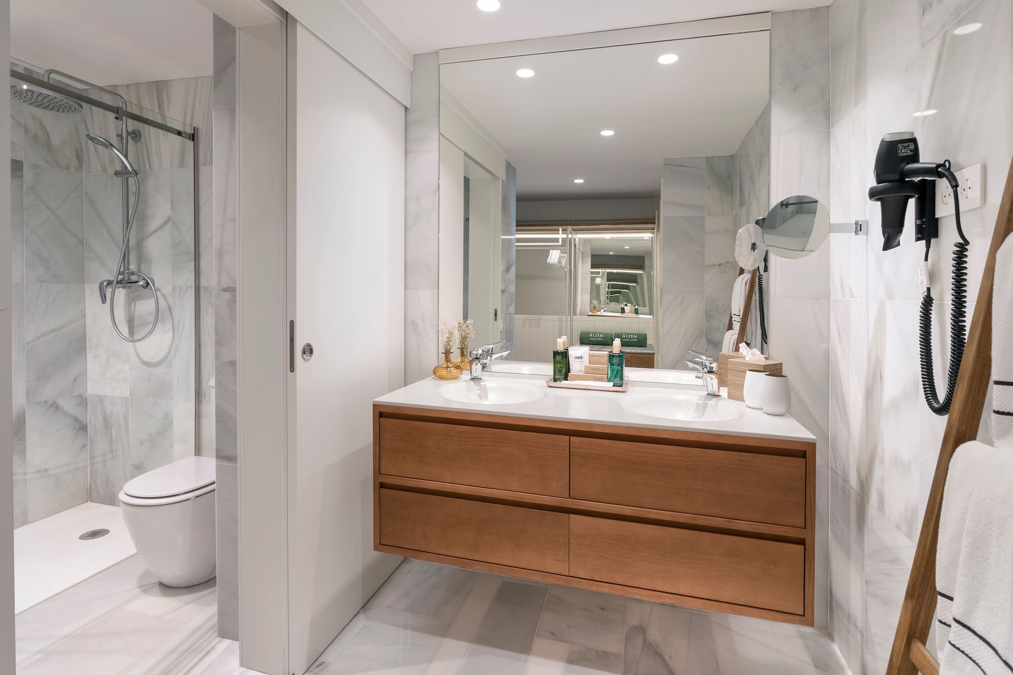 a bathroom with a large mirror and a sink