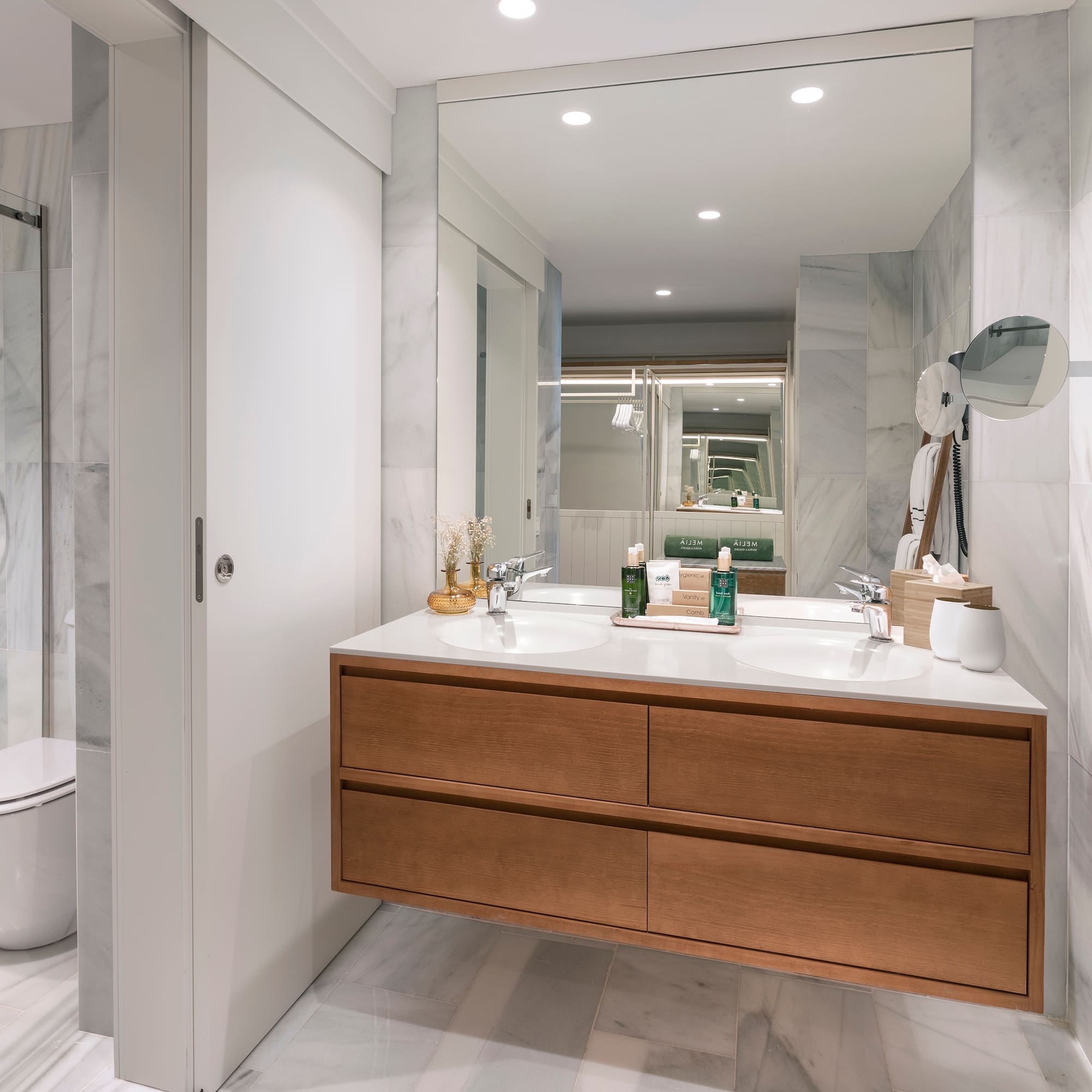 a bathroom with a large mirror and a sink