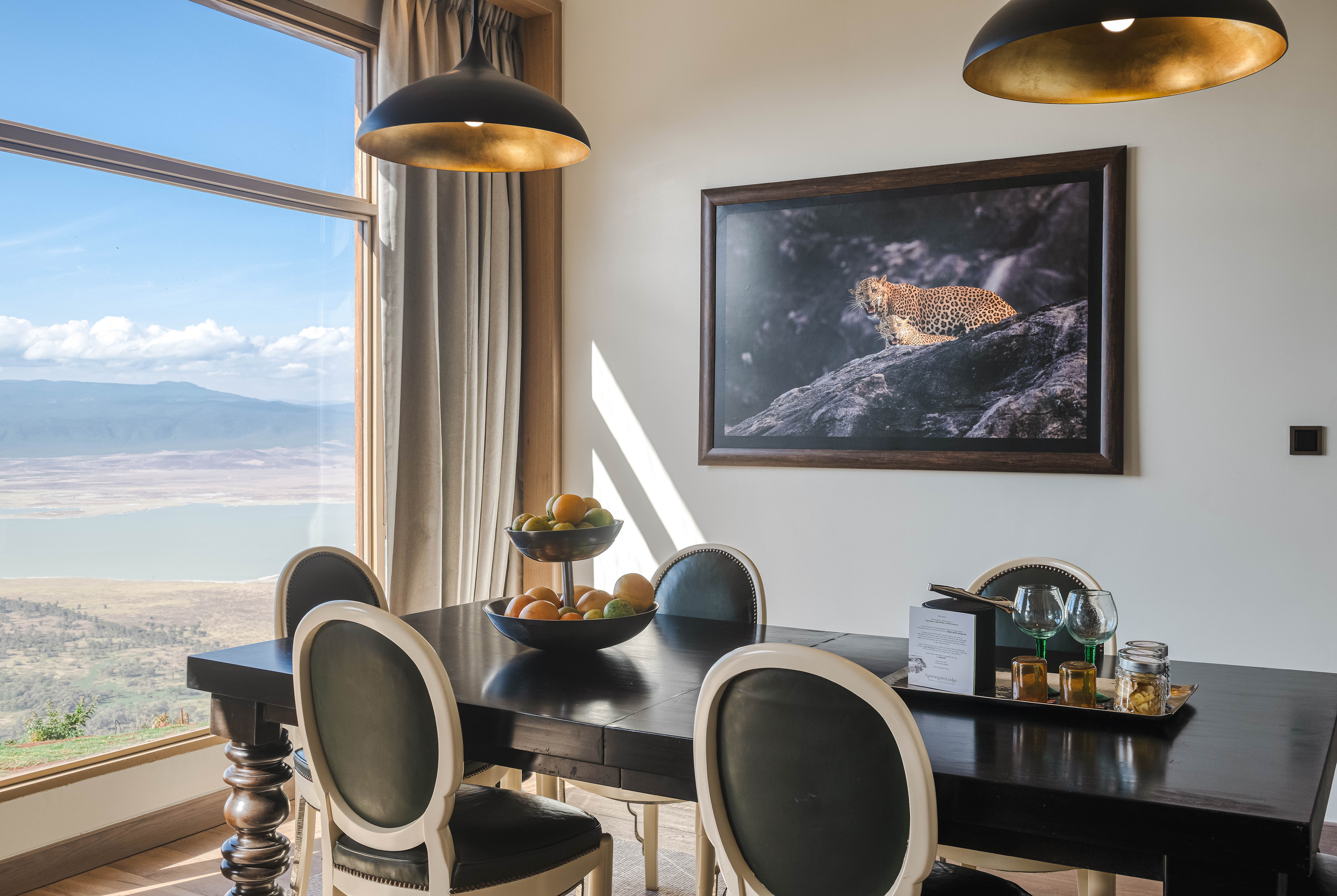 Ngorongoro lodge dining room with scenic crater view and leopard artwork.