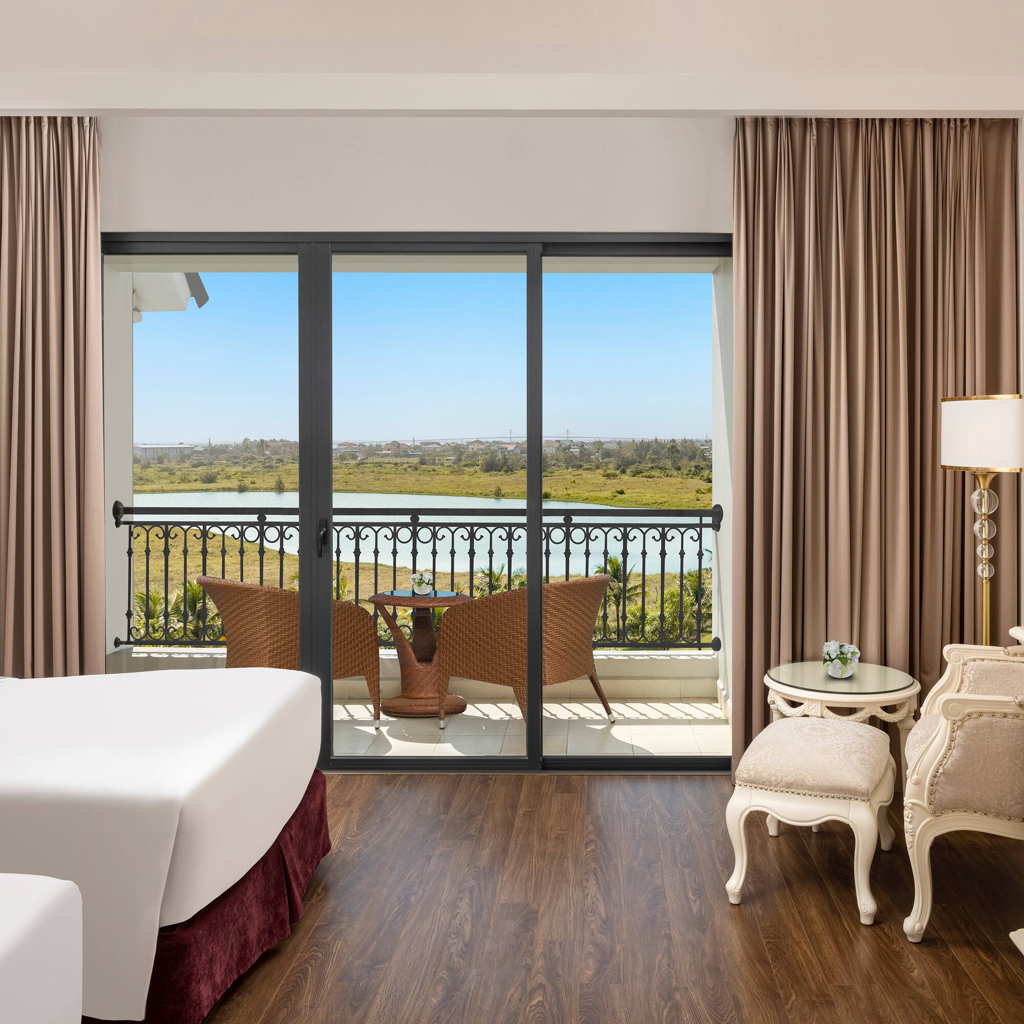a room with a view of the ocean and a balcony