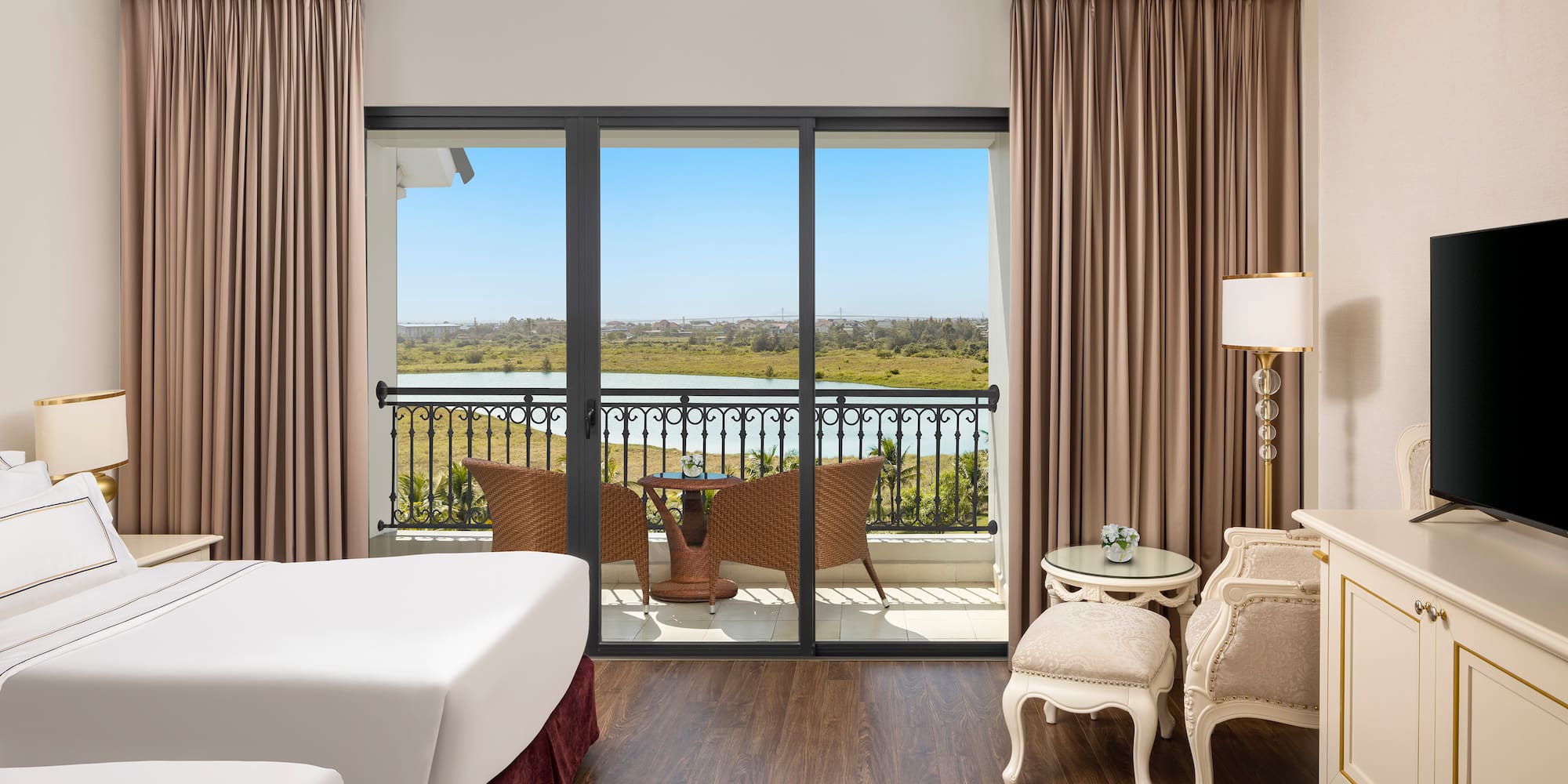 a room with a view of the ocean and a balcony