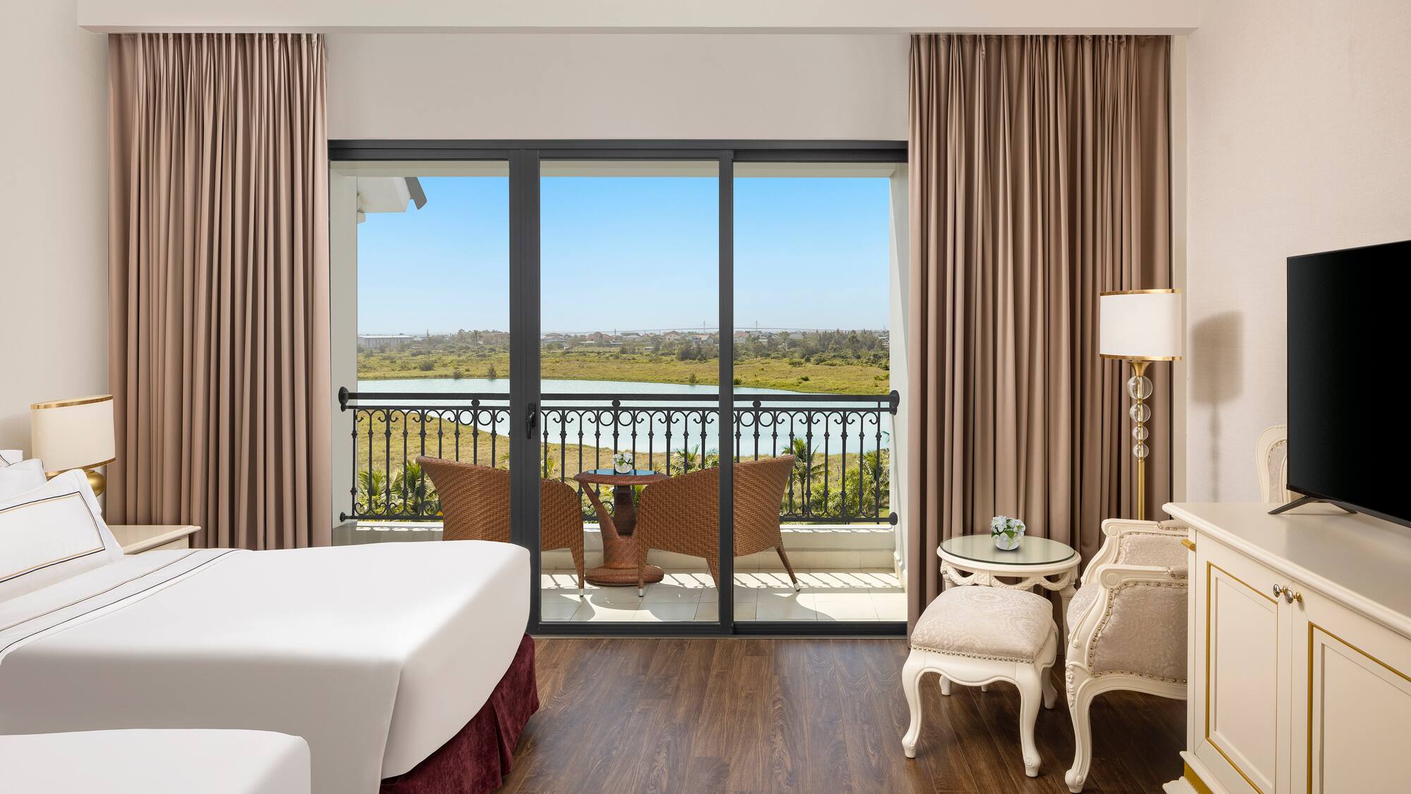 a room with a view of the ocean and a balcony