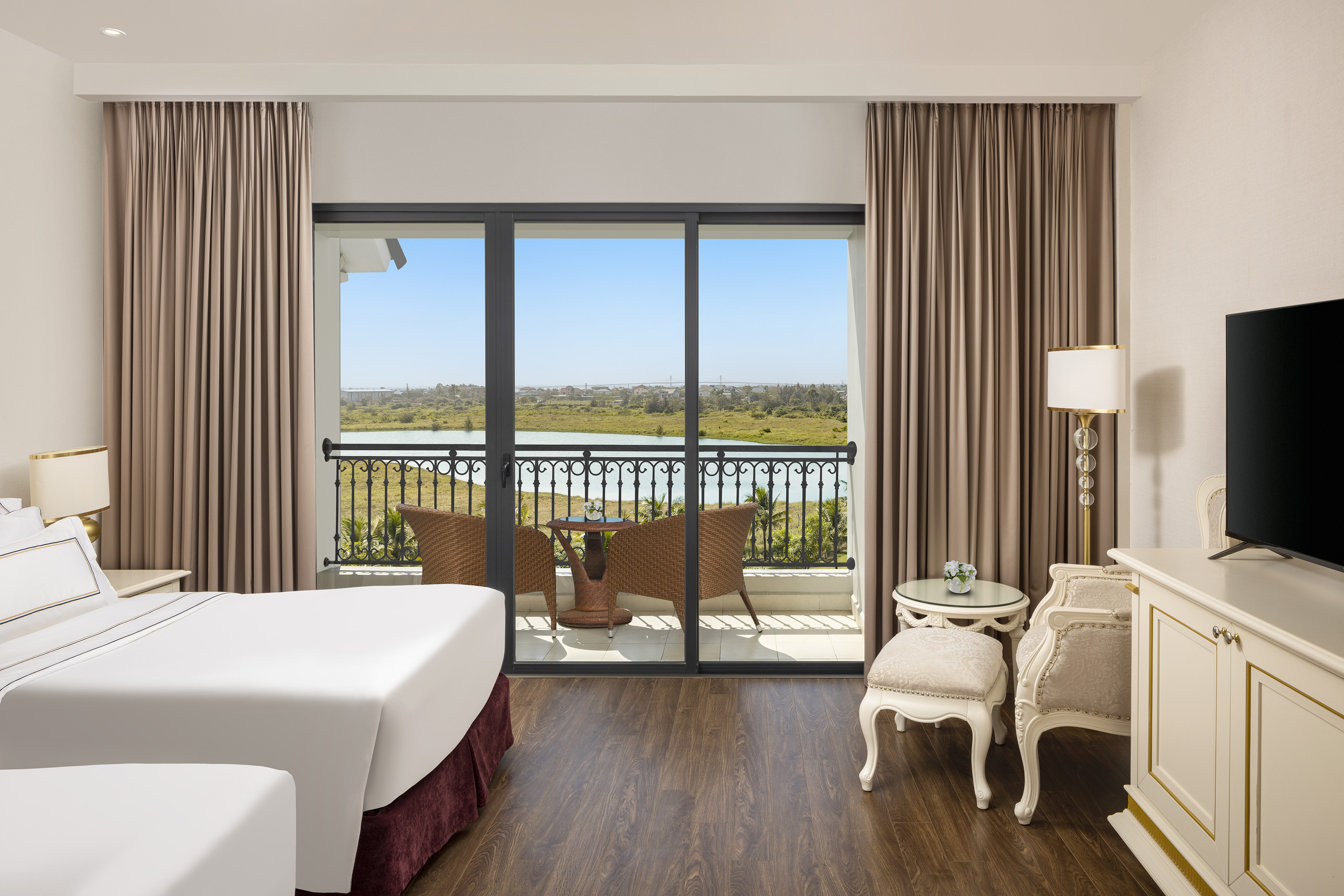a room with a view of the ocean and a balcony
