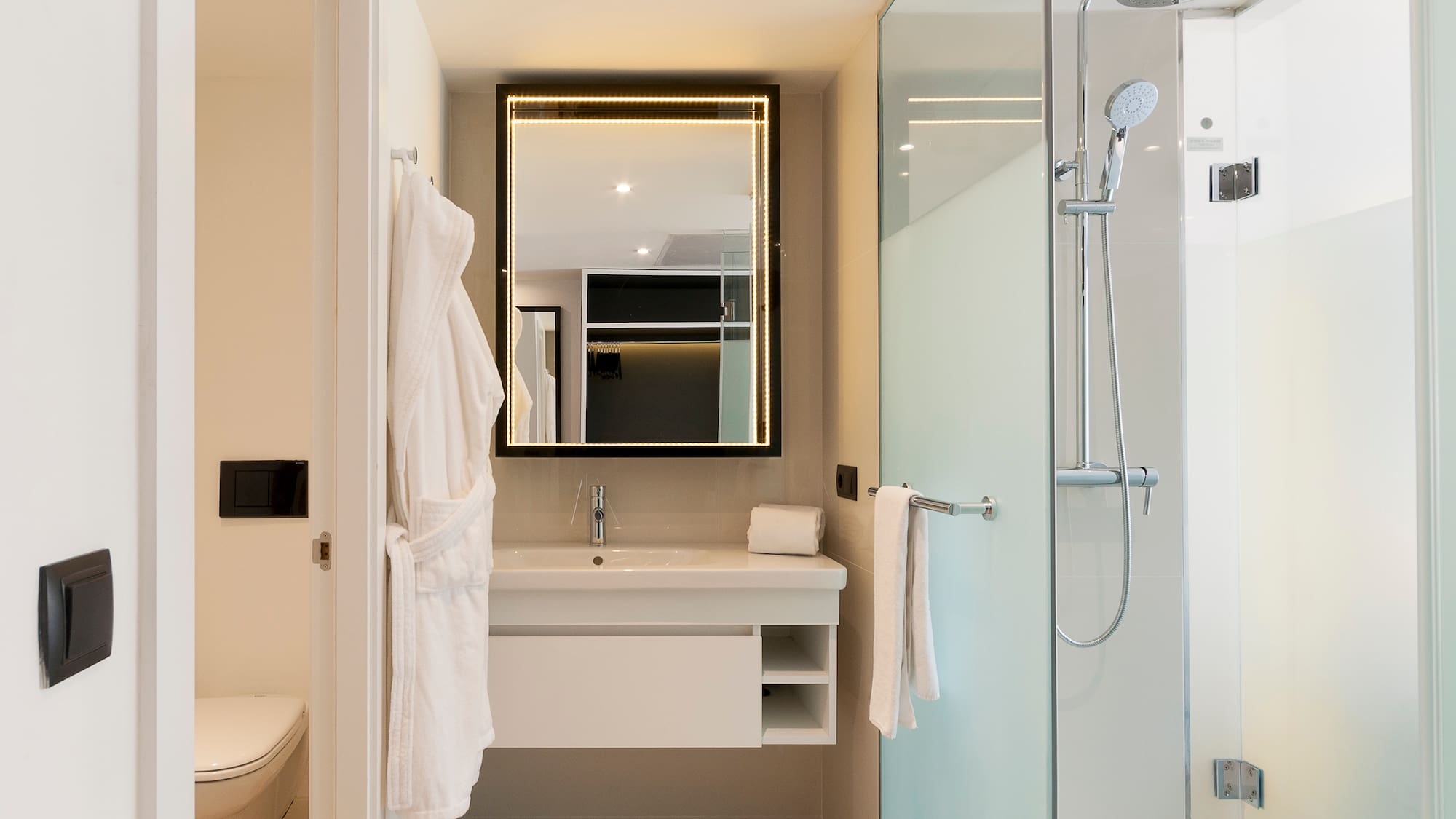 a bathroom with a glass shower and a sink
