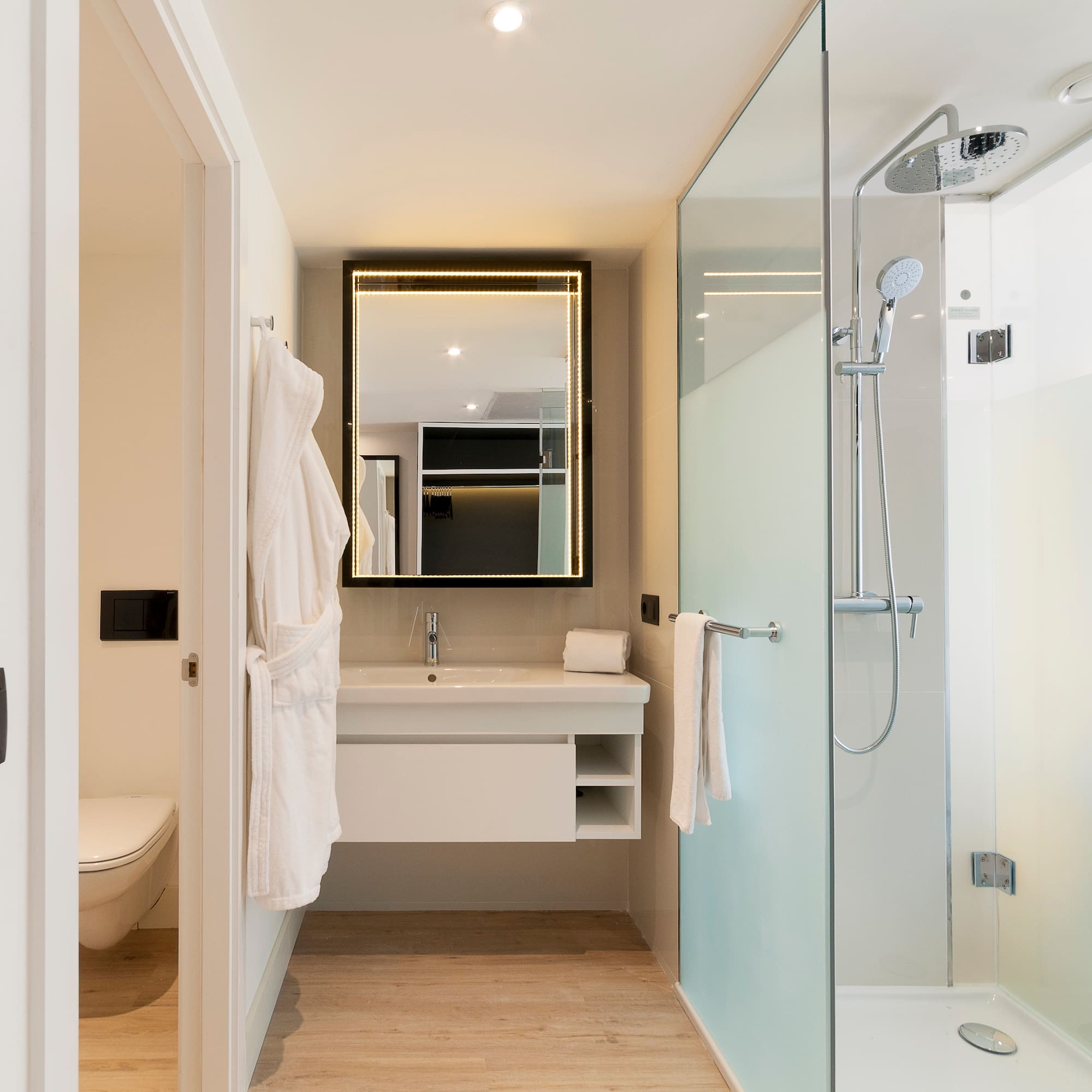 a bathroom with a glass shower and a sink
