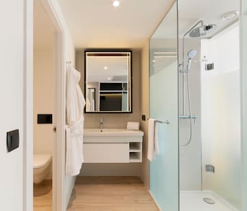 a bathroom with a glass shower and a sink