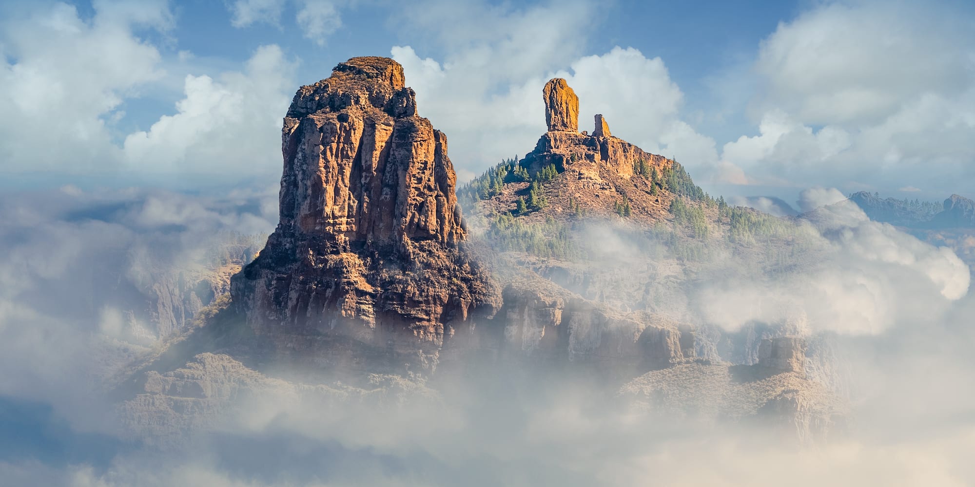 a rocky mountains with clouds