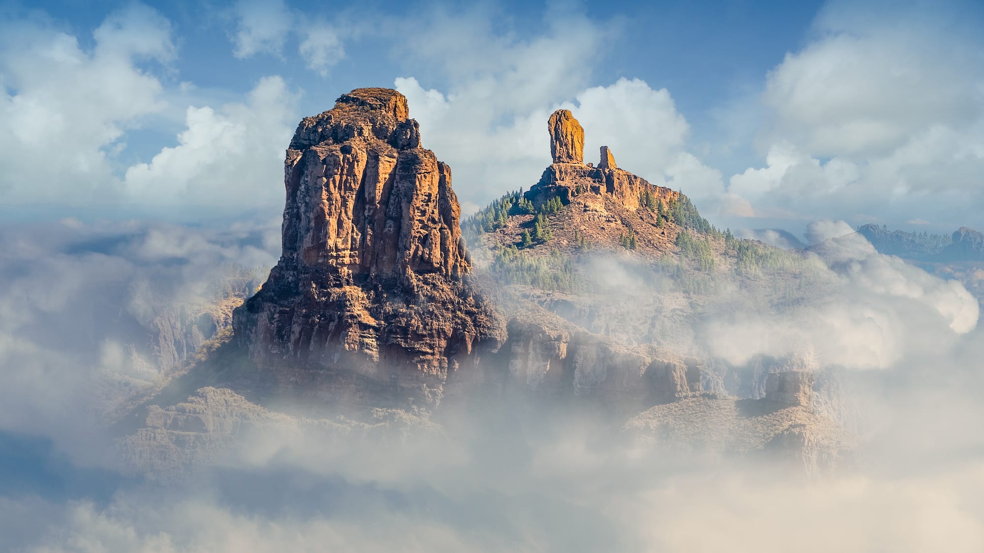 a rocky mountains with clouds