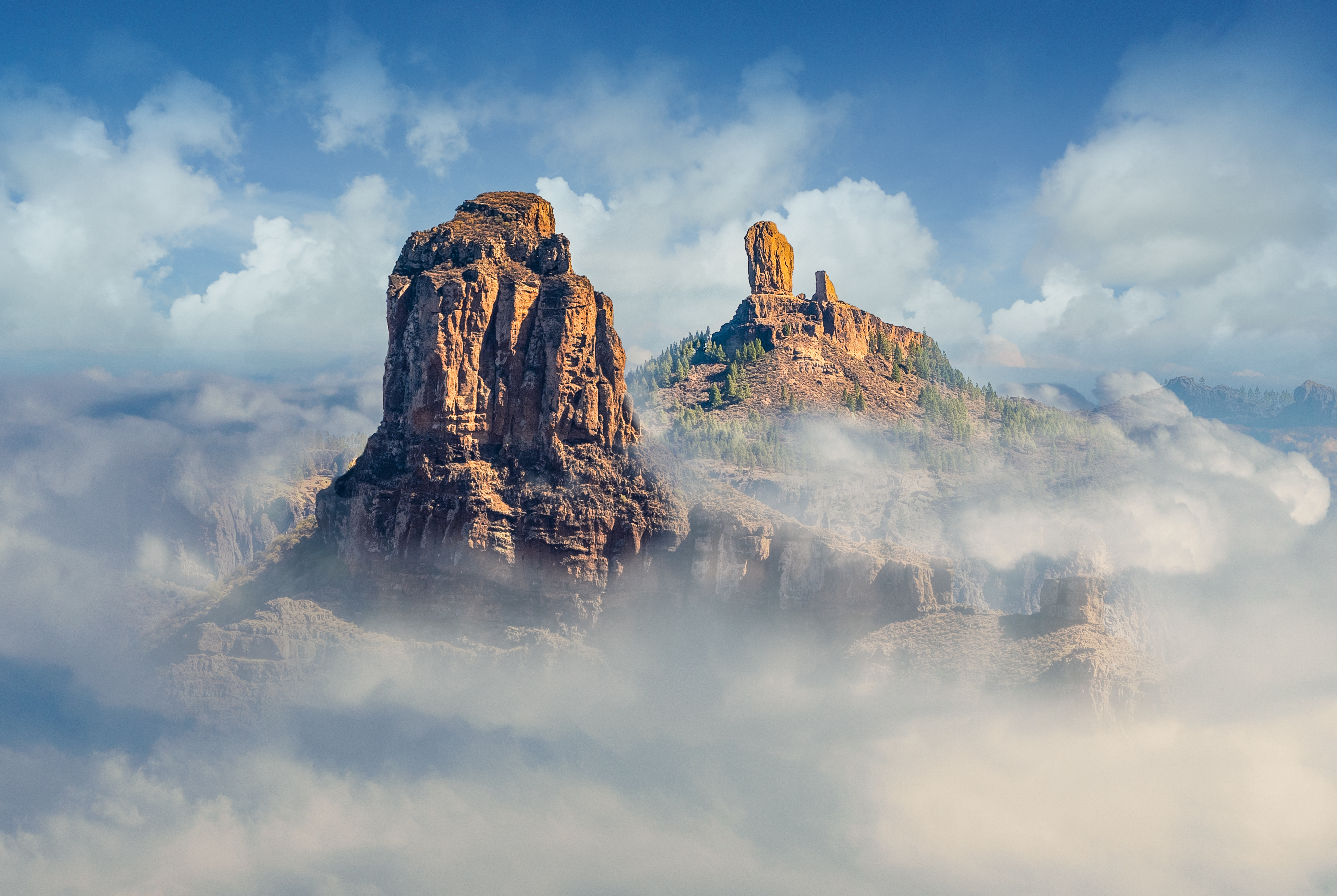 Roque Nublo and Roque Bentayga, Gran Canaria peaks rising above misty clouds.