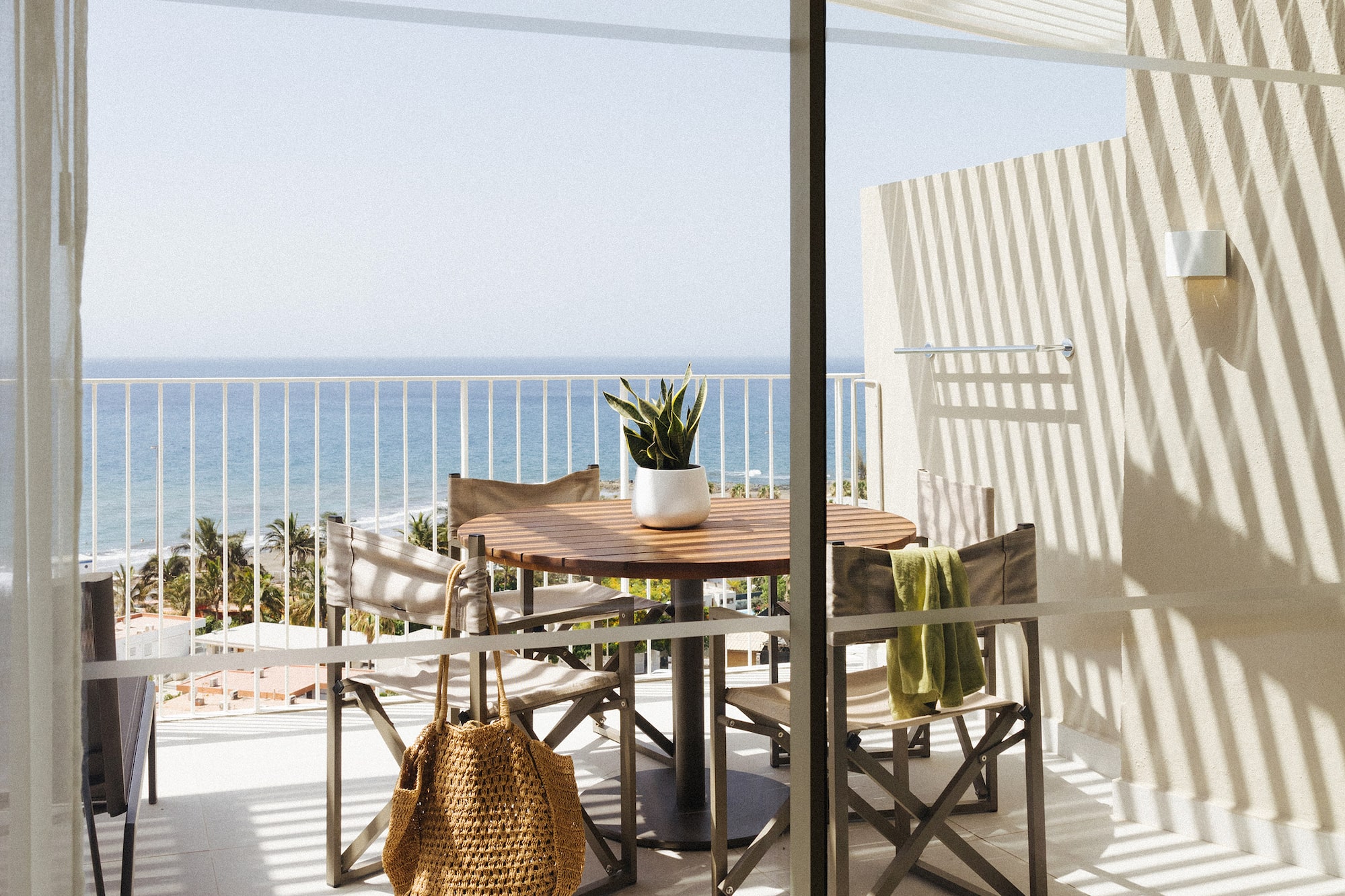 a table and chairs on a balcony overlooking a body of water