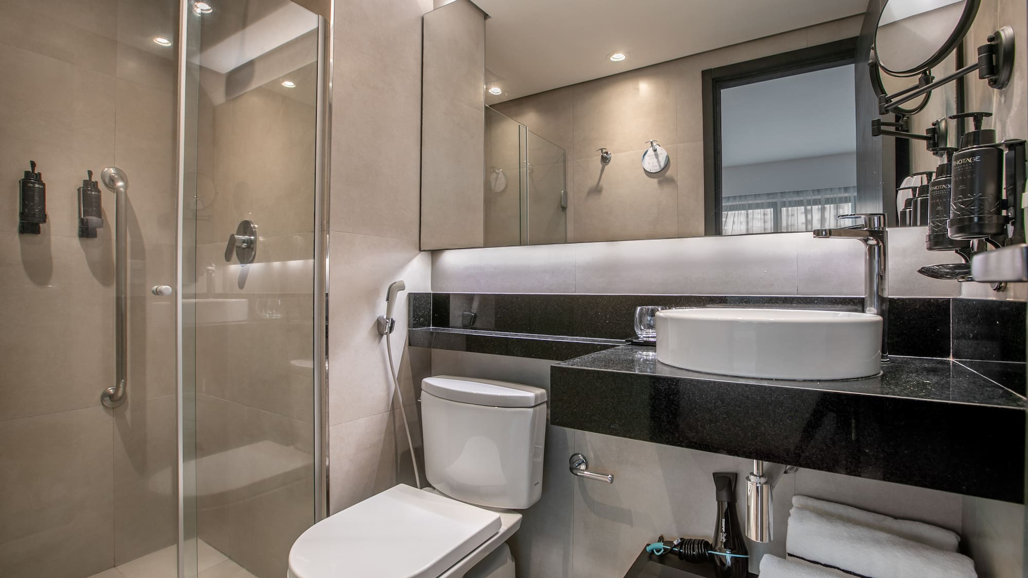 Modern hotel bathroom with glass shower, vessel sink, and toilet. - Deluxe Room Twin - Meliá Ibirapuera, São Paulo