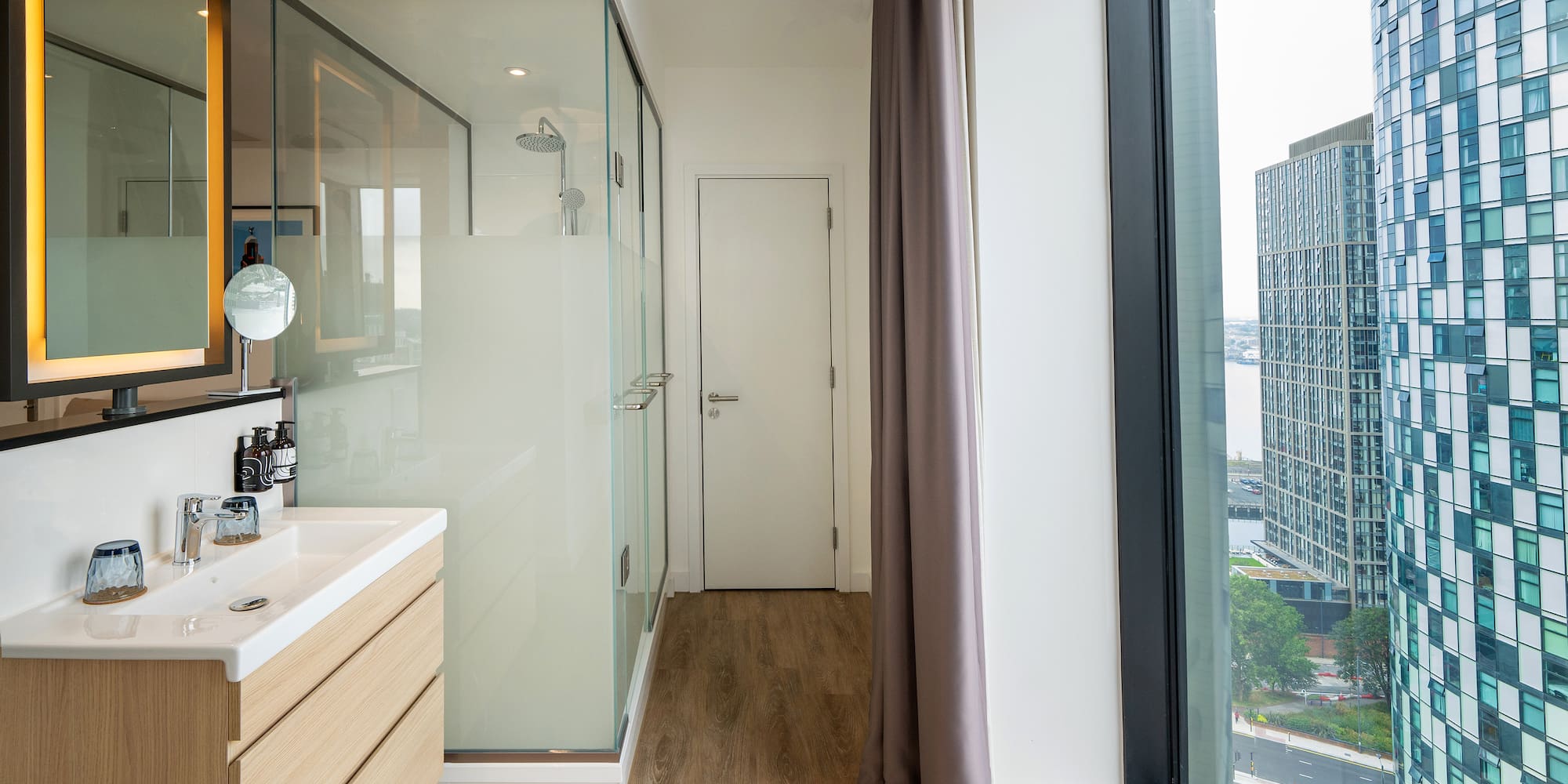 a bathroom with a shower and a large window