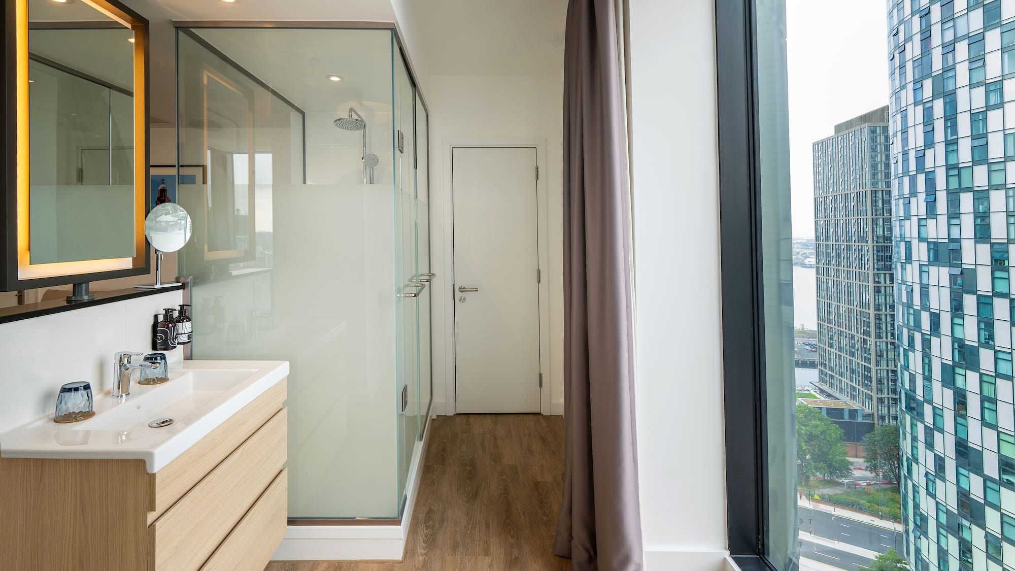 a bathroom with a shower and a large window