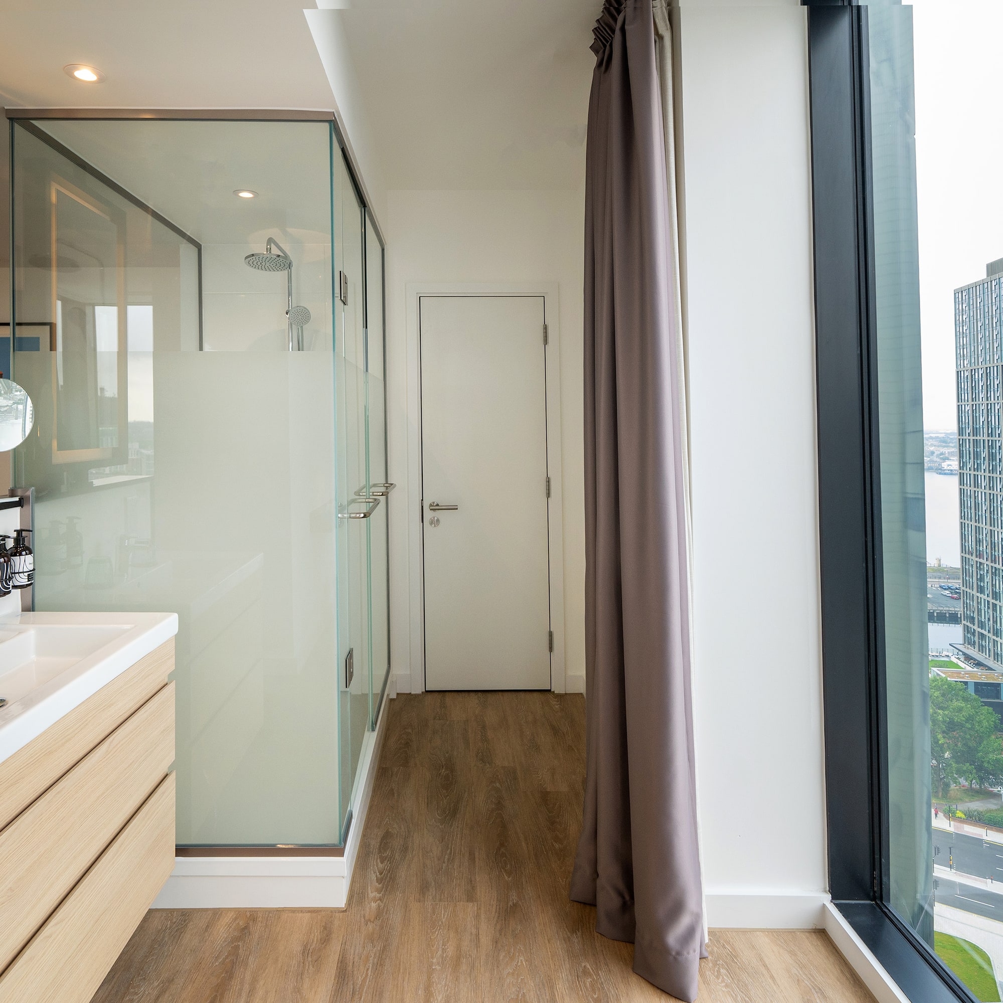 a bathroom with a shower and a large window