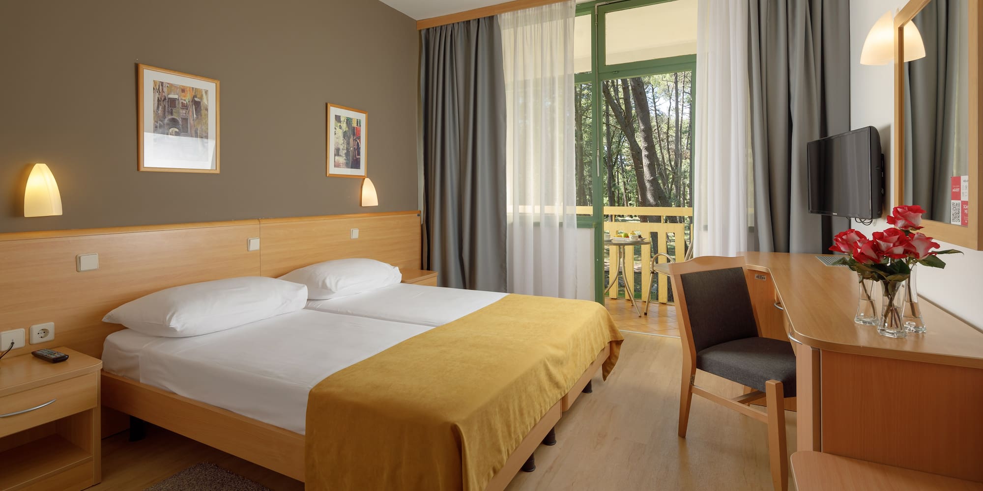 a room with a bed and a table and chairs