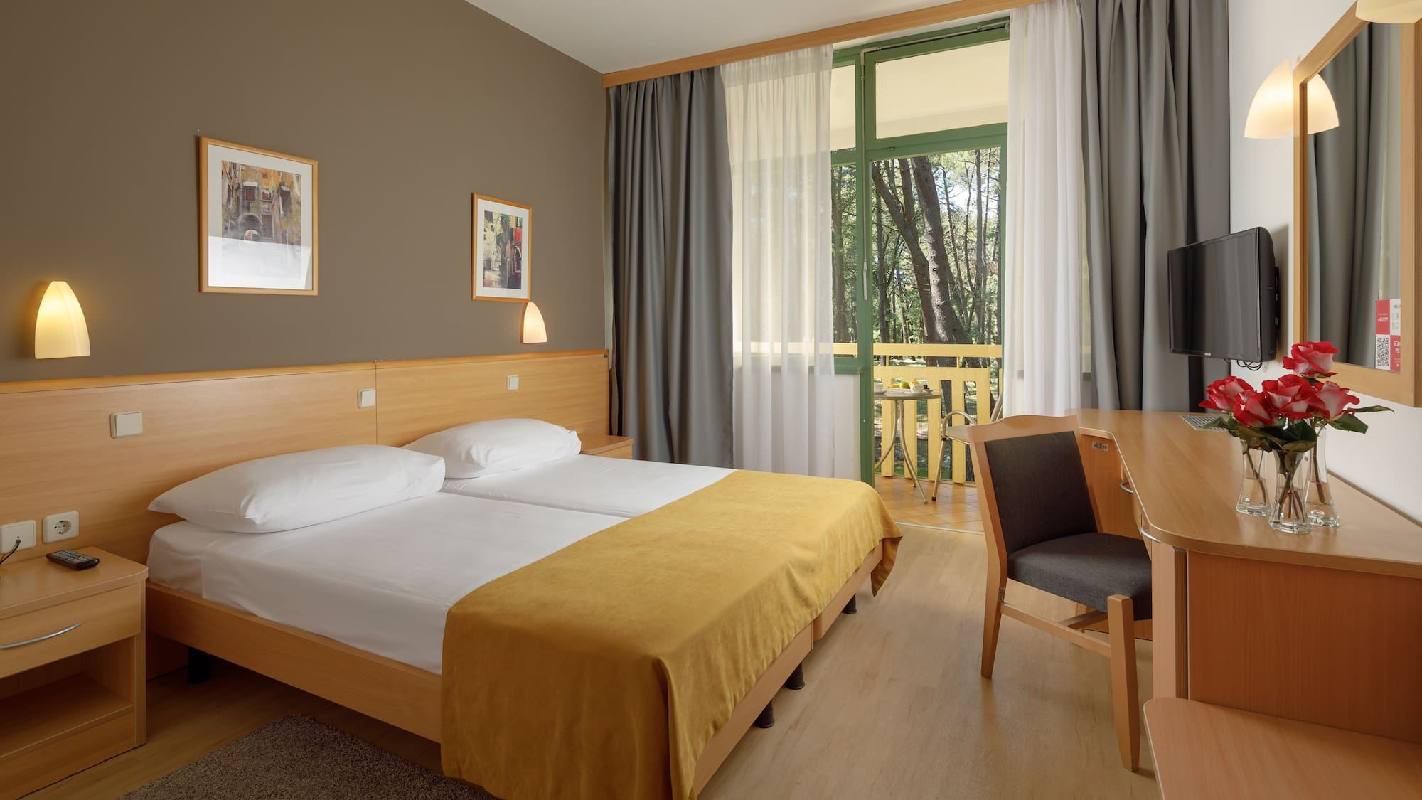 a room with a bed and a table and chairs