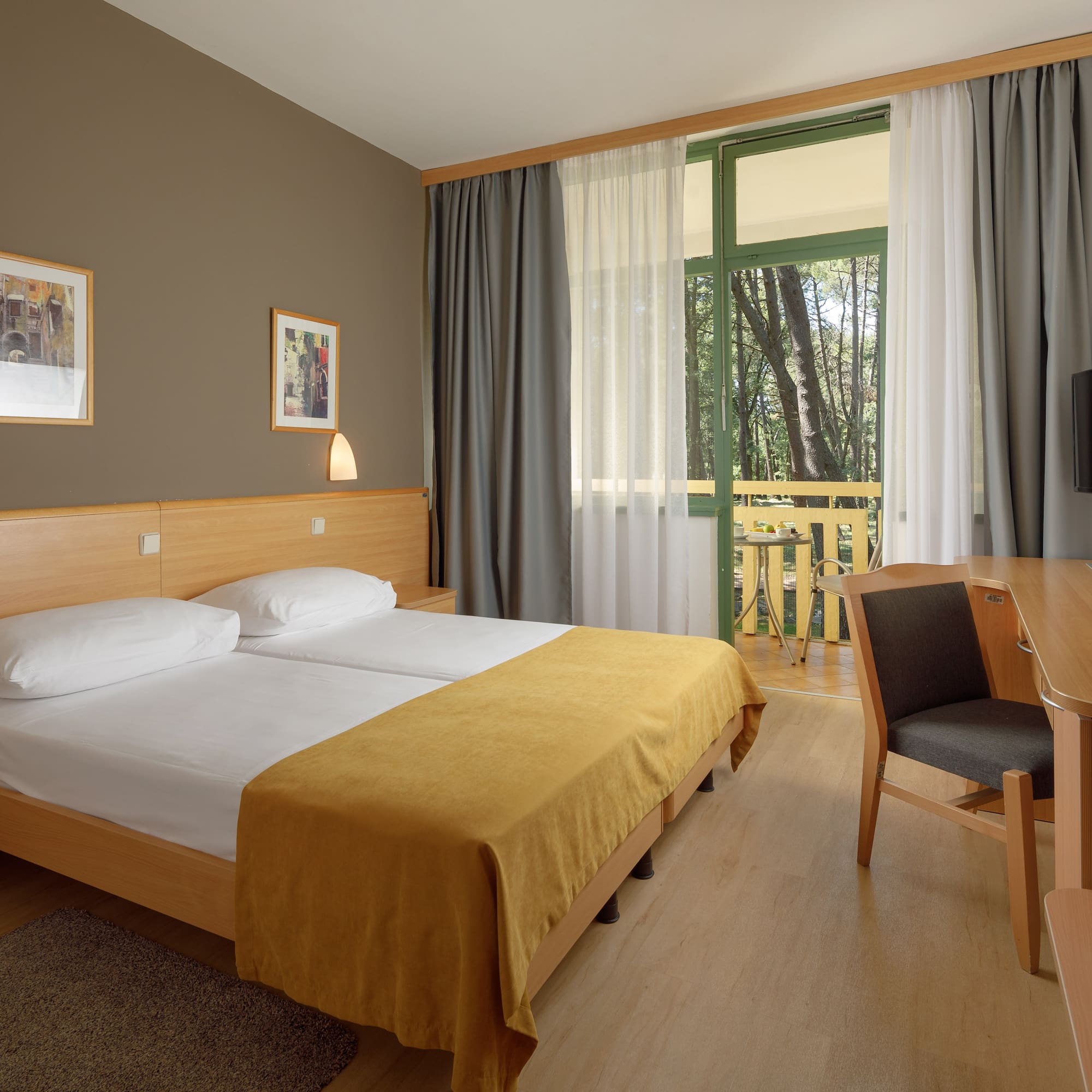 a room with a bed and a table and chairs