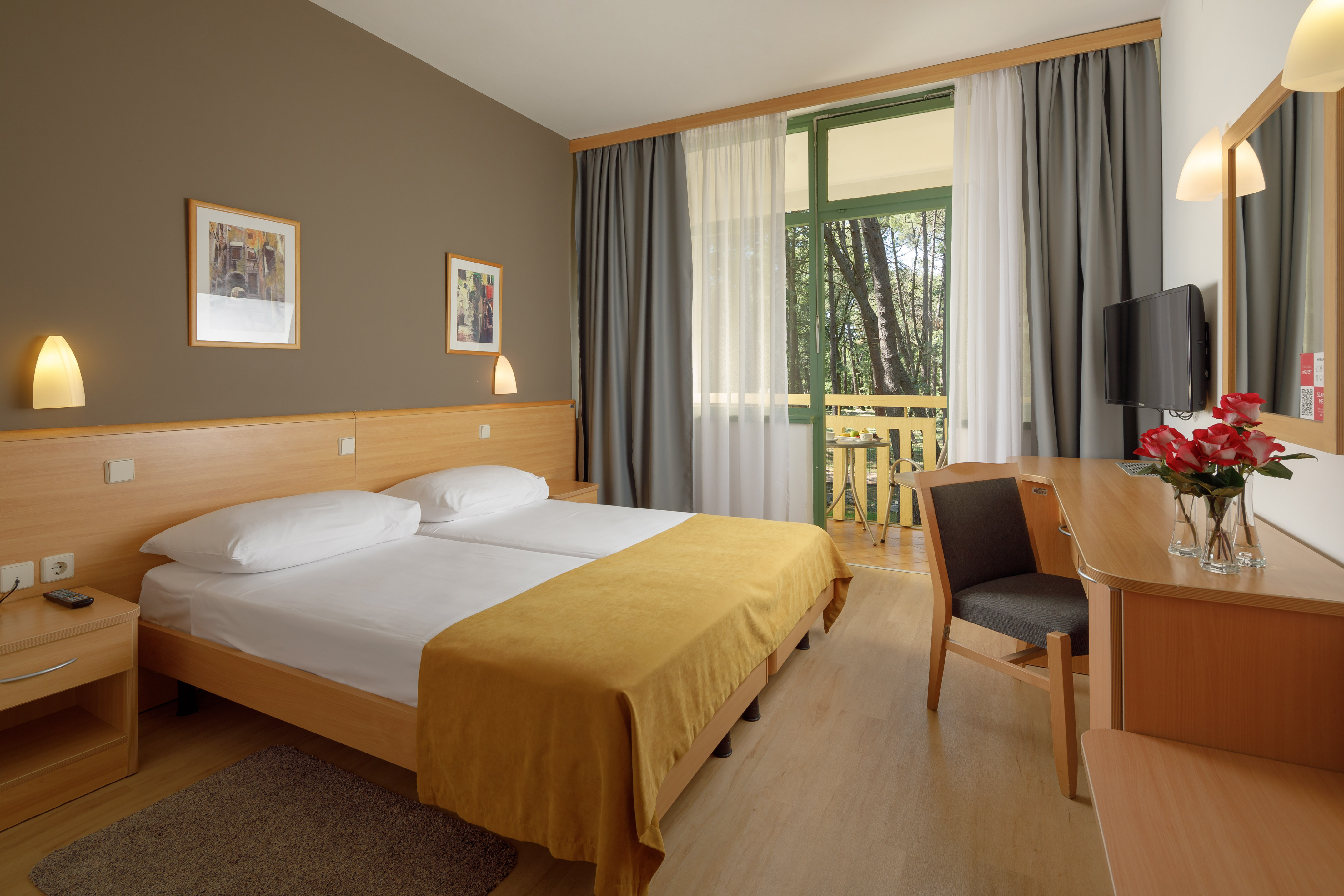 a room with a bed and a table and chairs