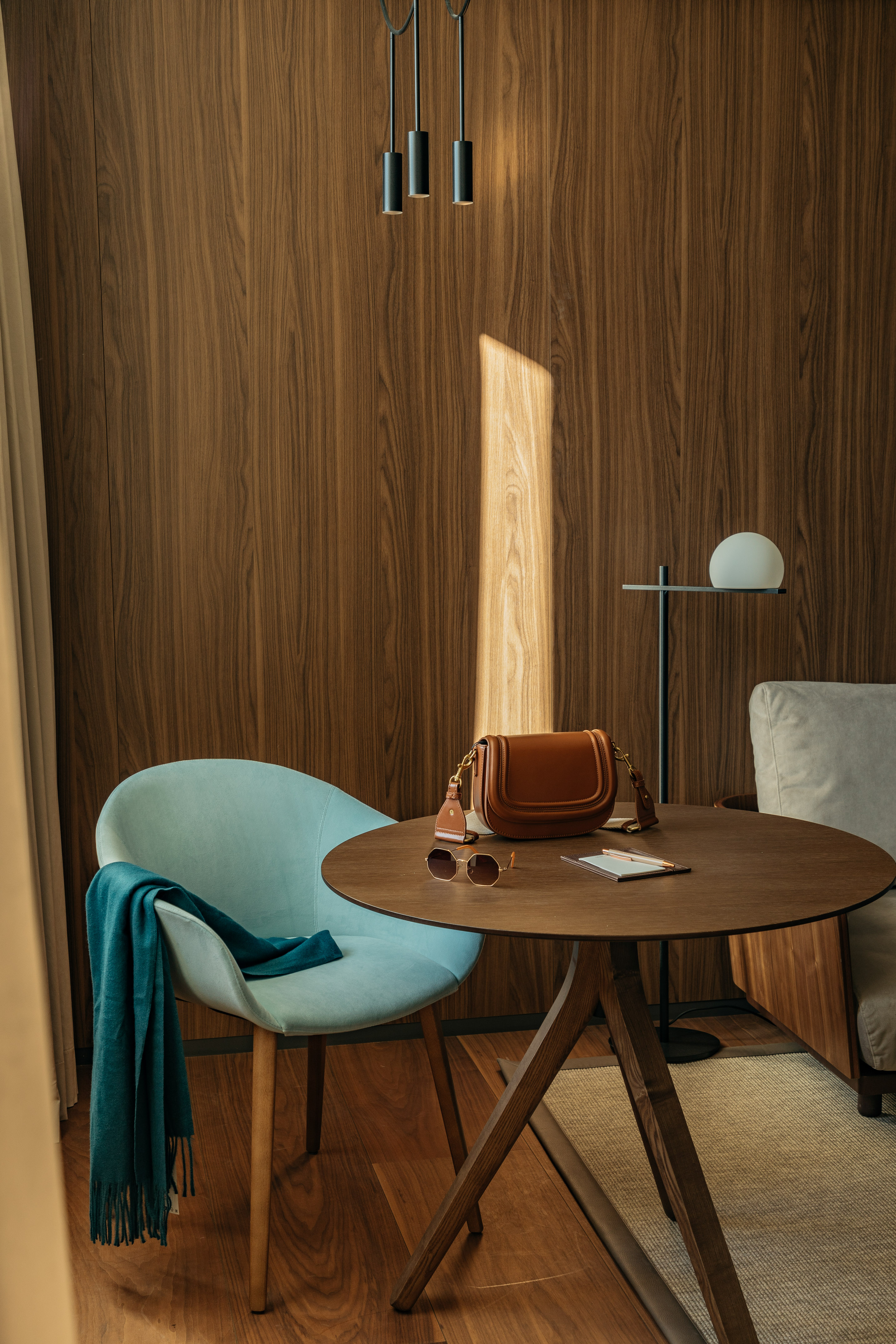 a chair and a table with a purse on it