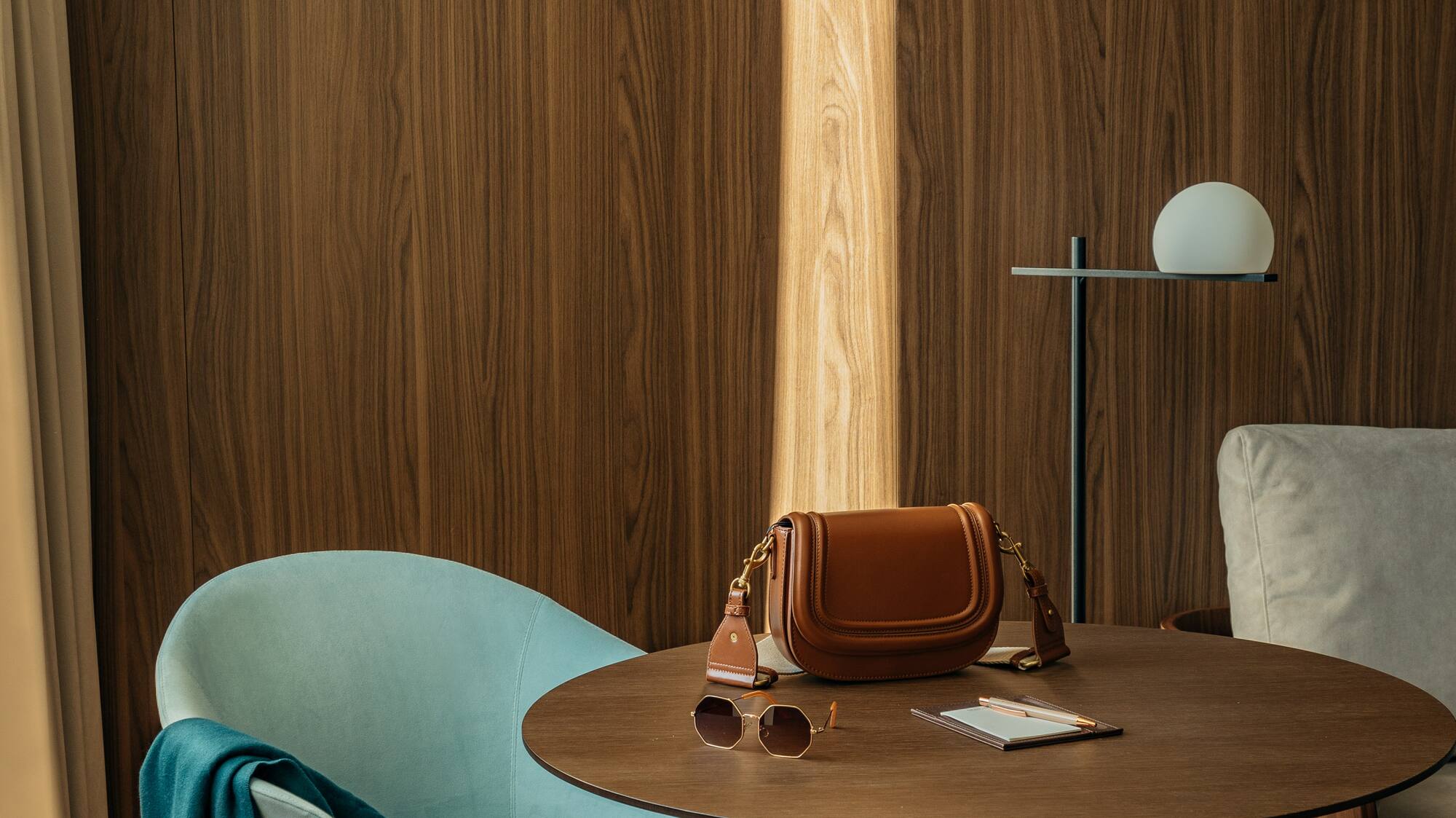 a chair and a table with a purse on it