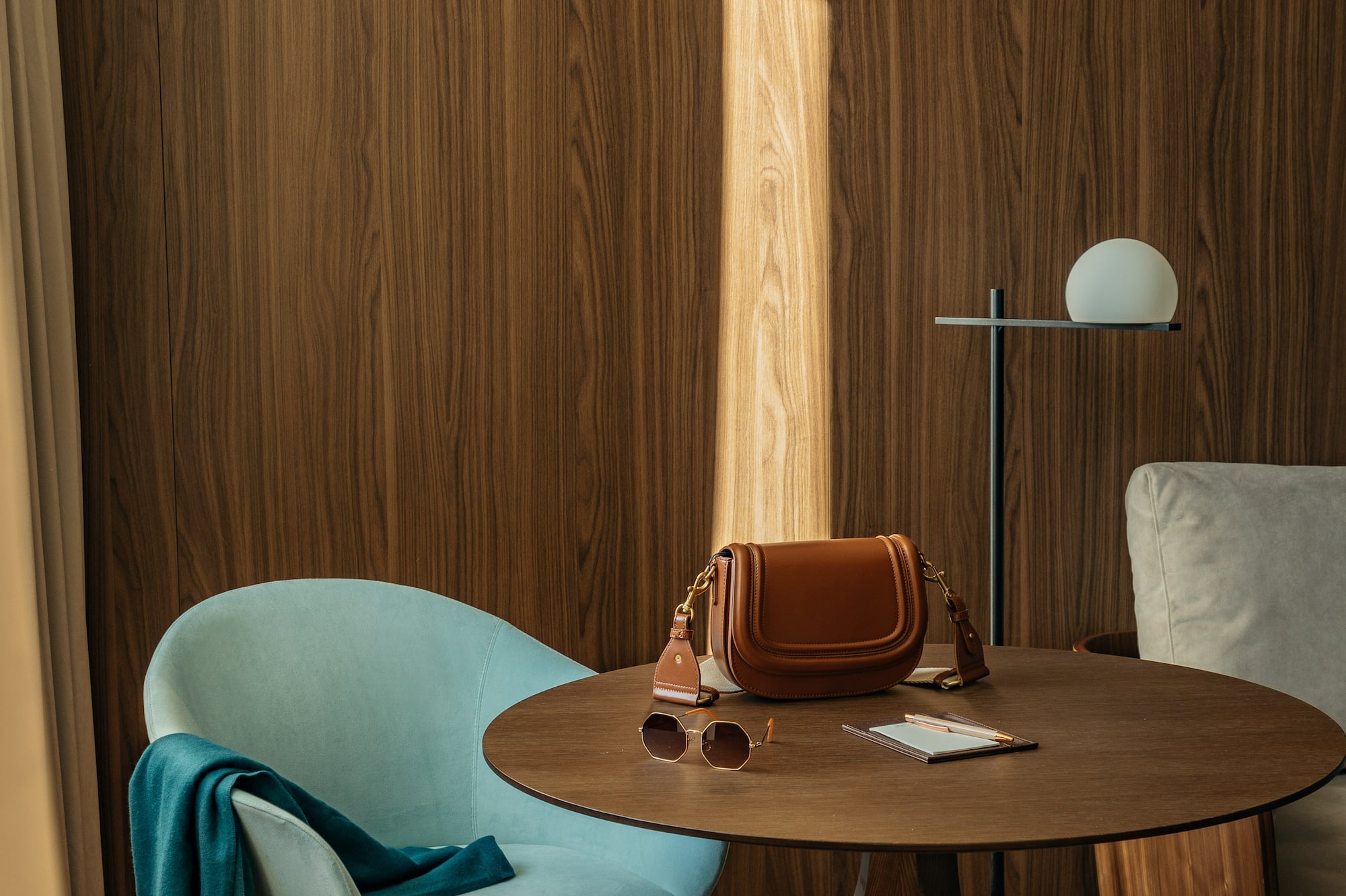 a chair and a table with a purse on it