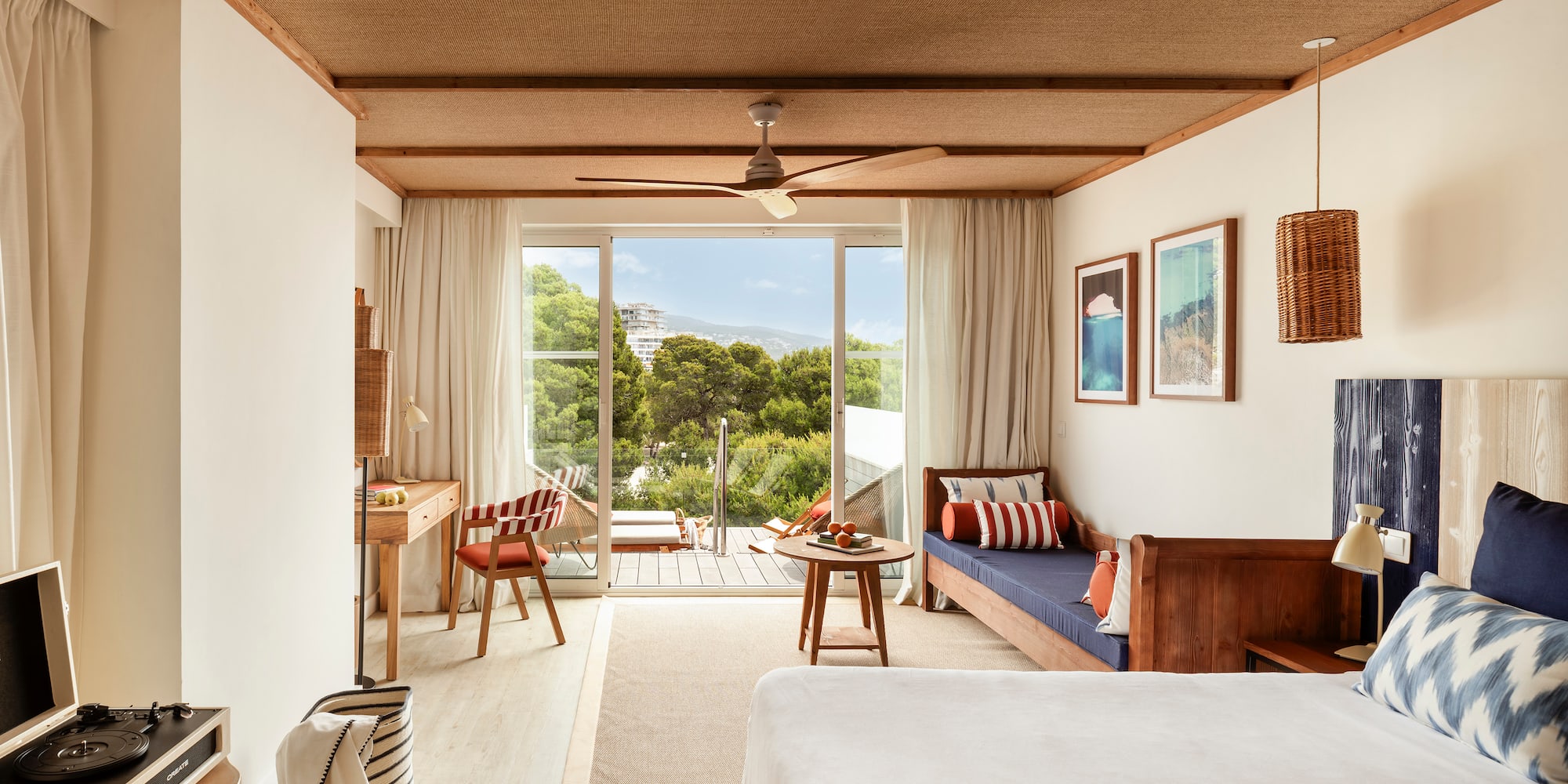 a room with a bed, table and chairs