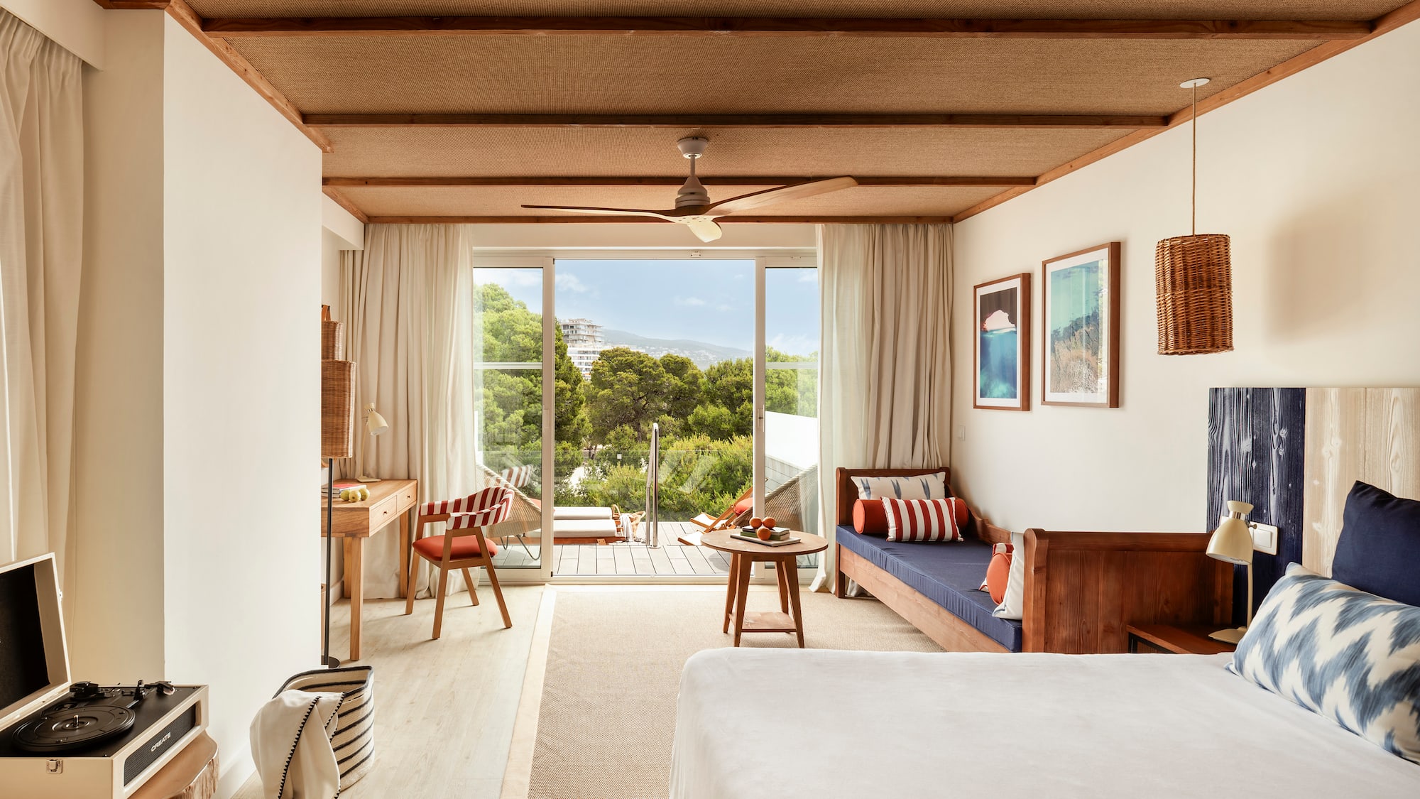 a room with a bed, table and chairs