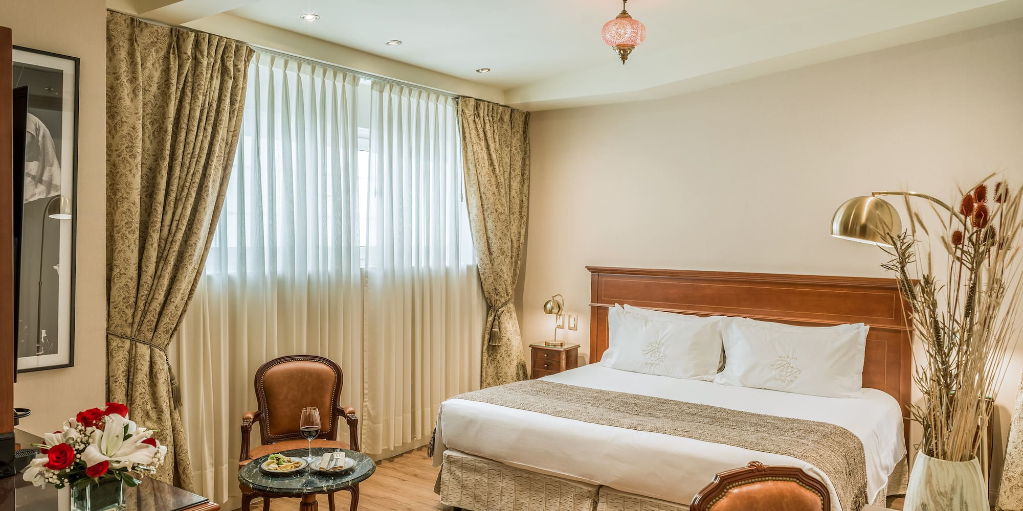 a room with a bed and chairs