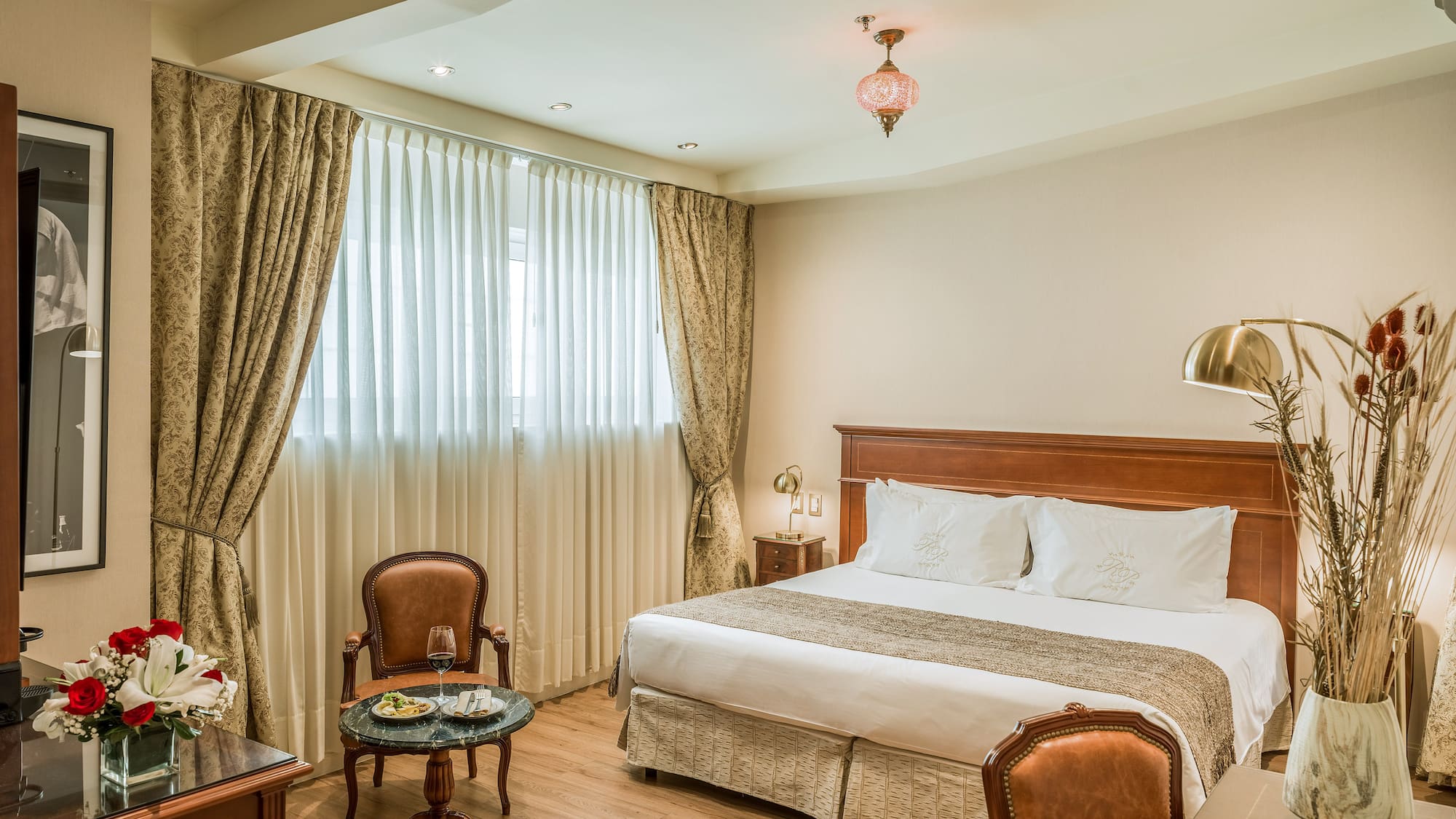 a room with a bed and chairs