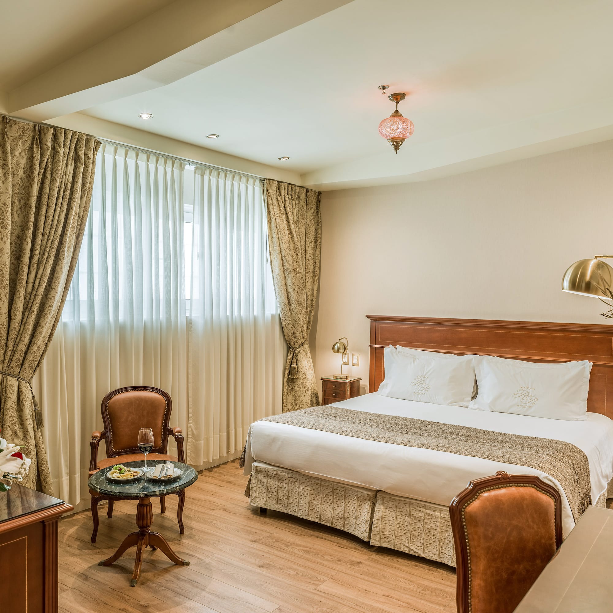 a room with a bed and chairs