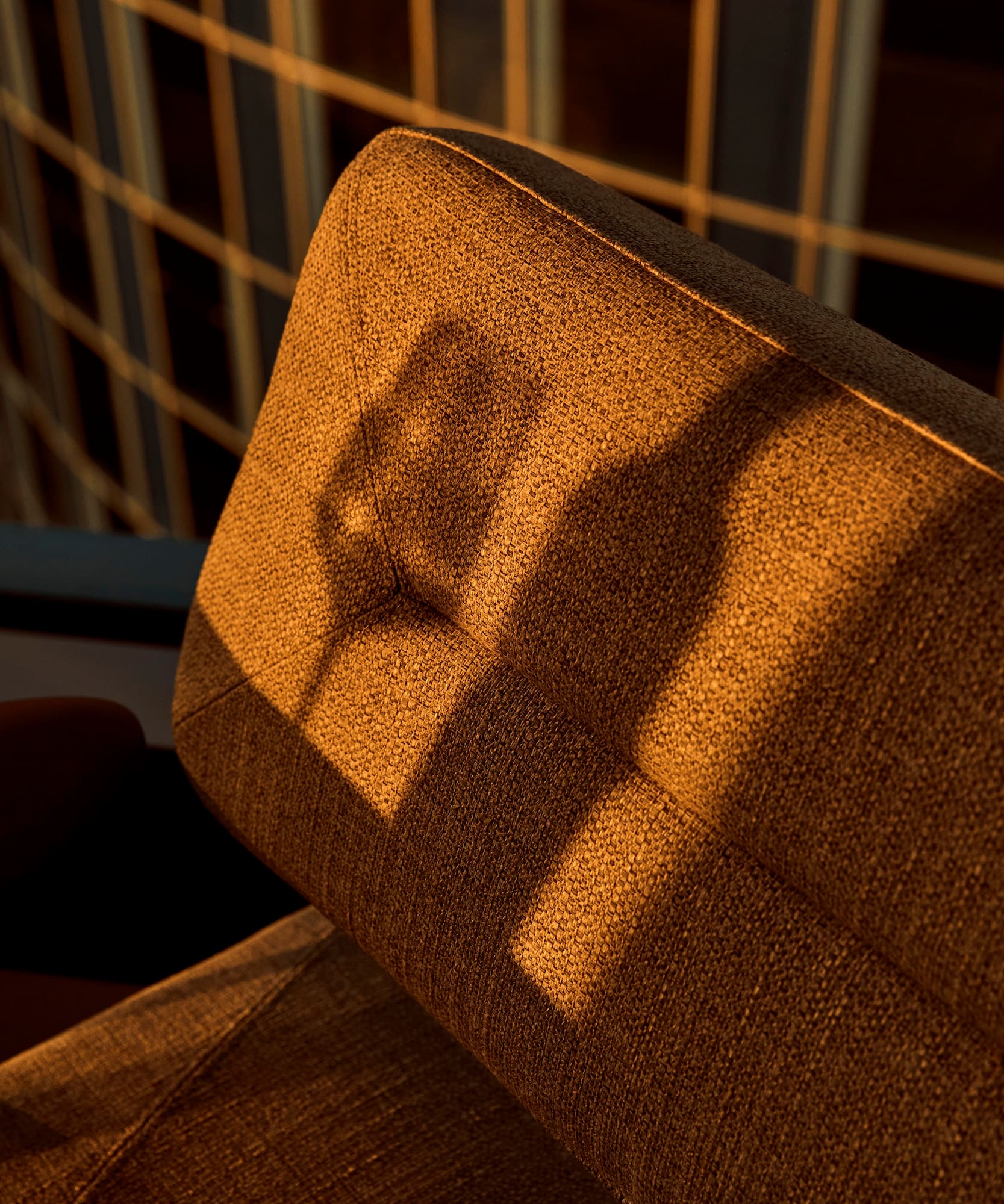 a chair with a shadow of a bottle on it