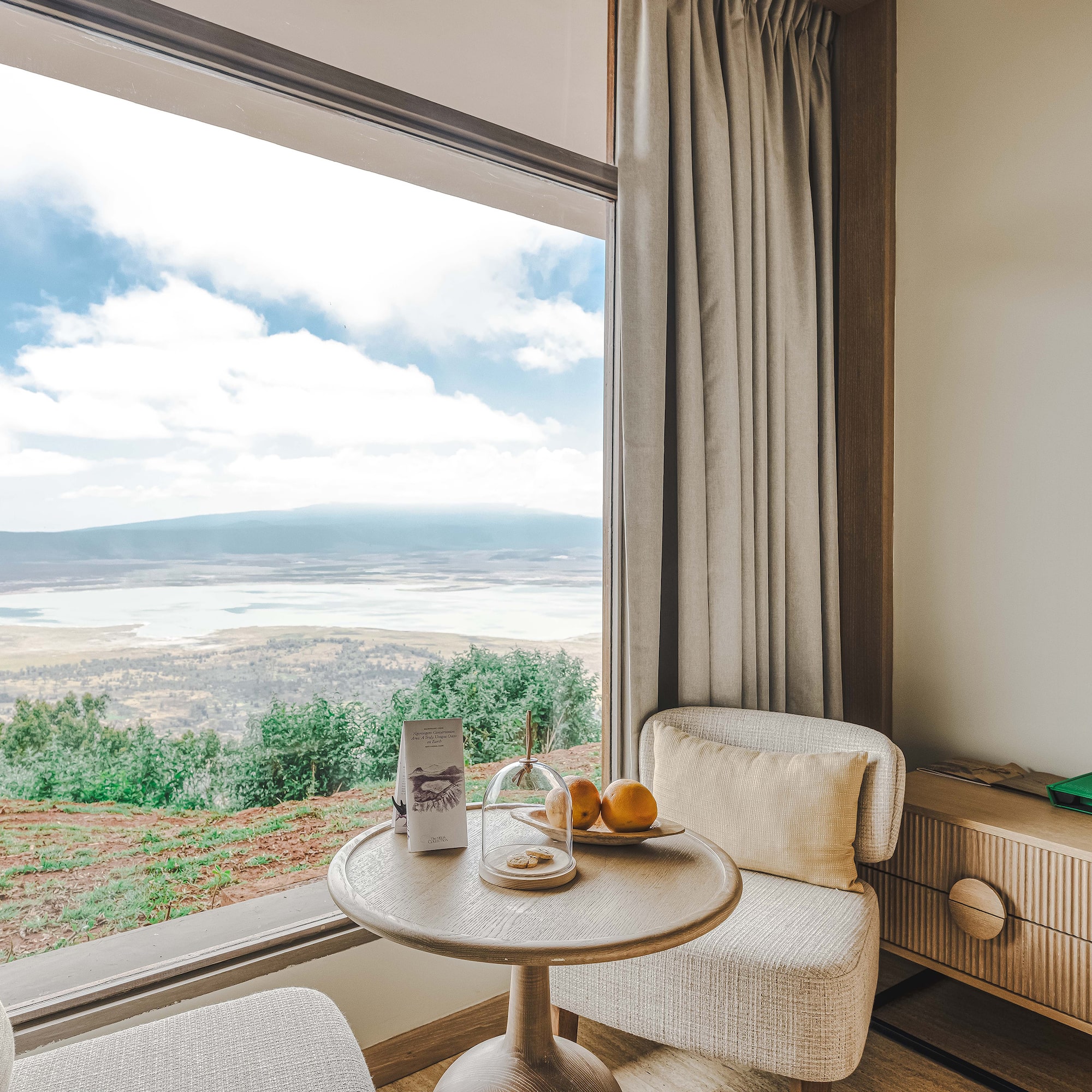 a room with a window and a table and chairs