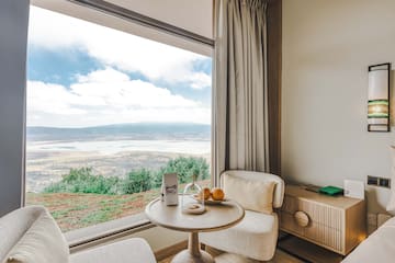 a room with a window and a table and chairs