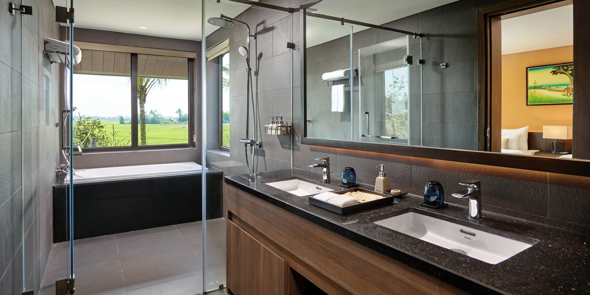 a bathroom with a large glass shower and a tub