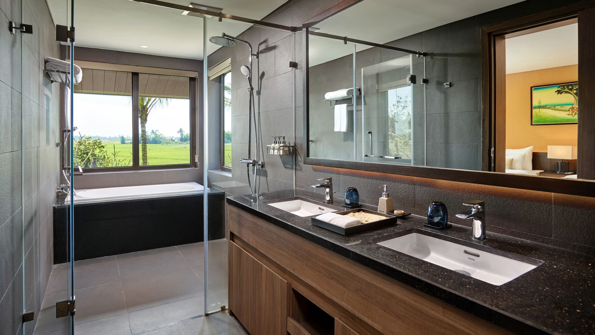 a bathroom with a large glass shower and a tub