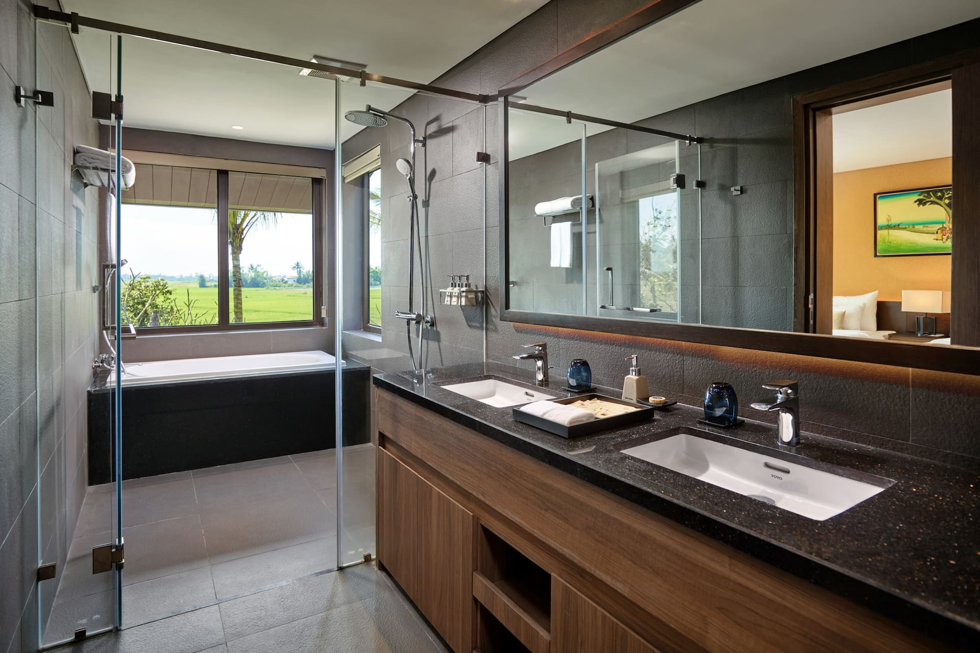 a bathroom with a large glass shower and a tub