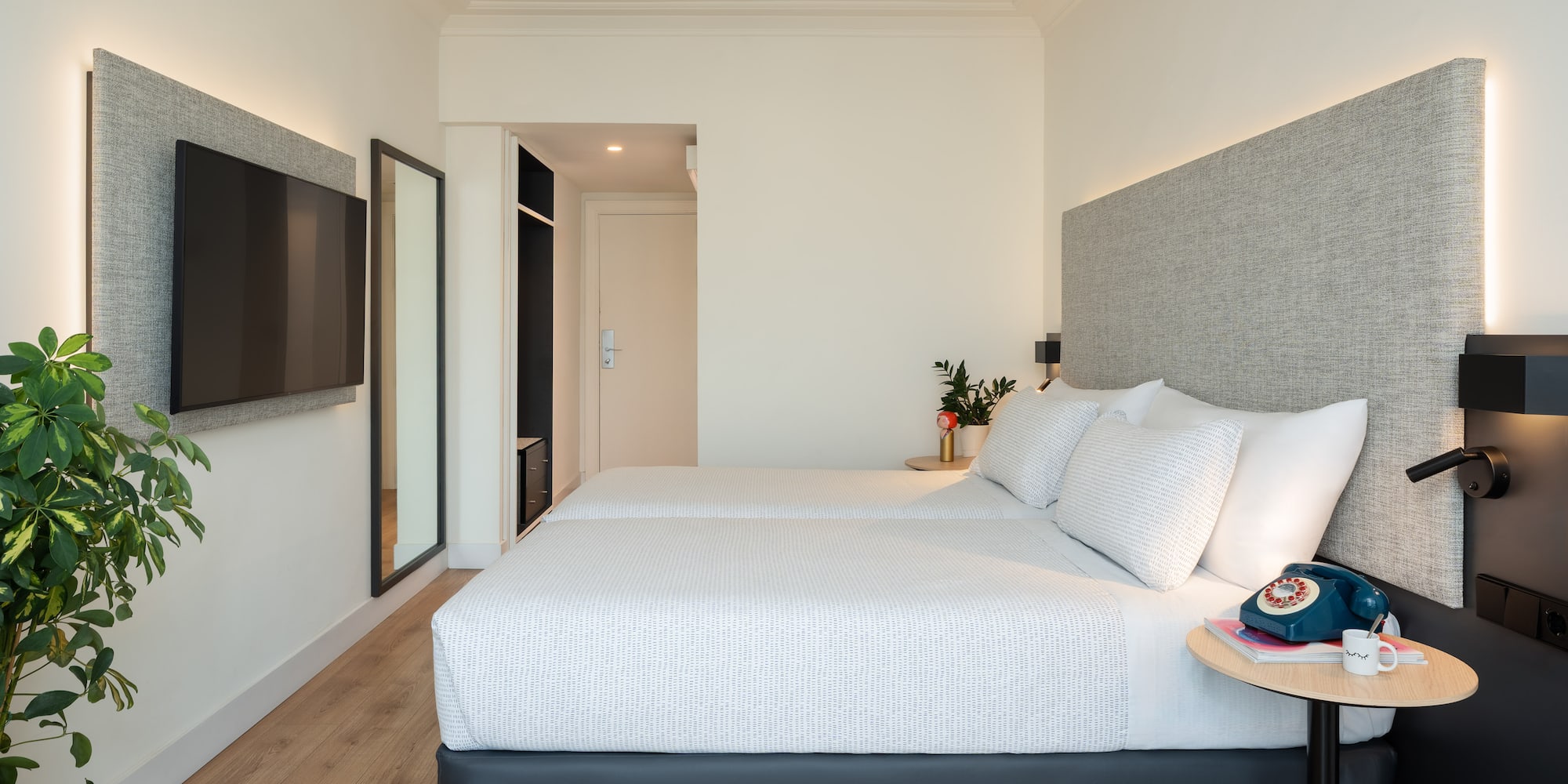 a bedroom with a bed and a tv