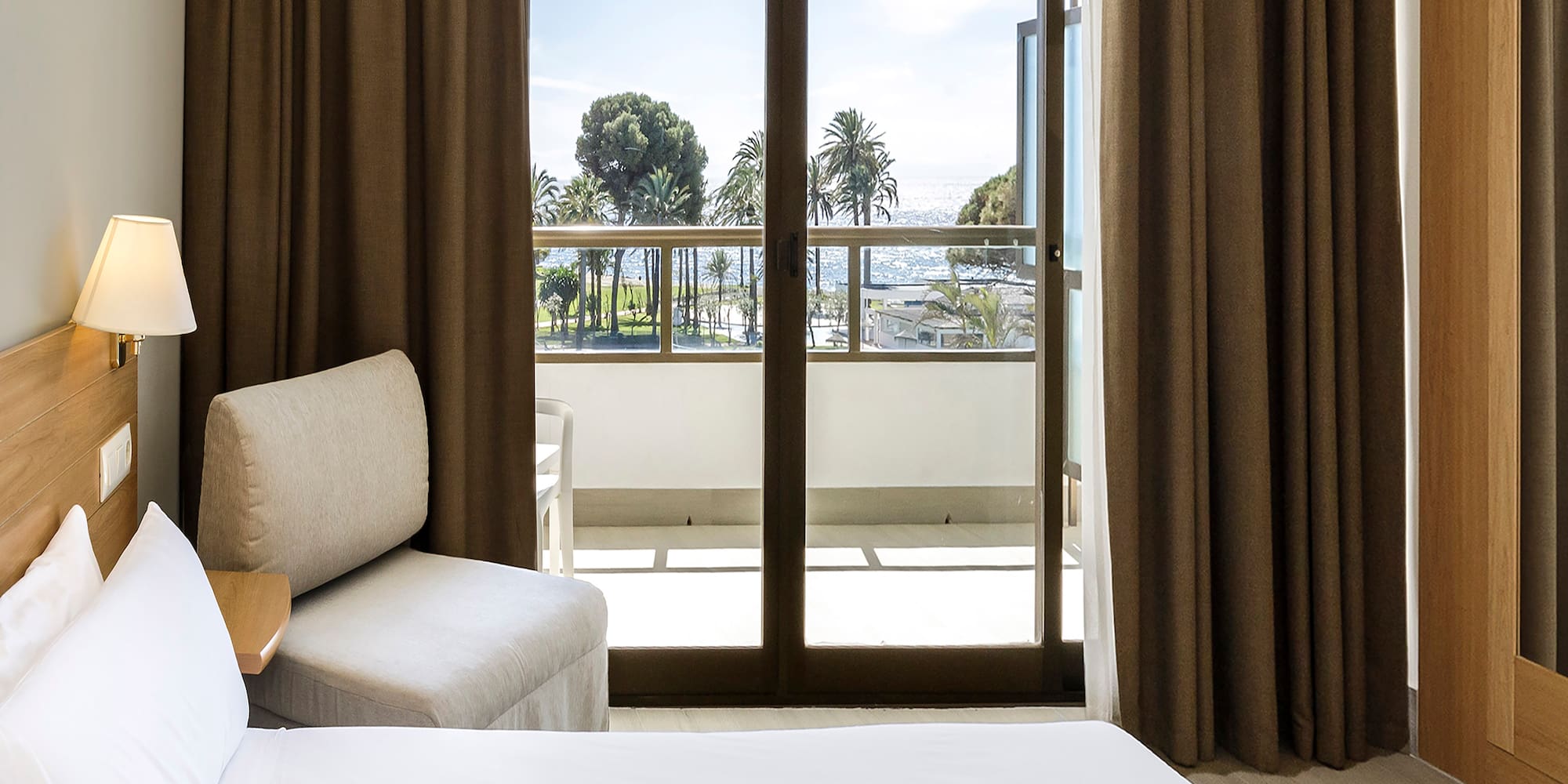 a room with a bed and a glass door