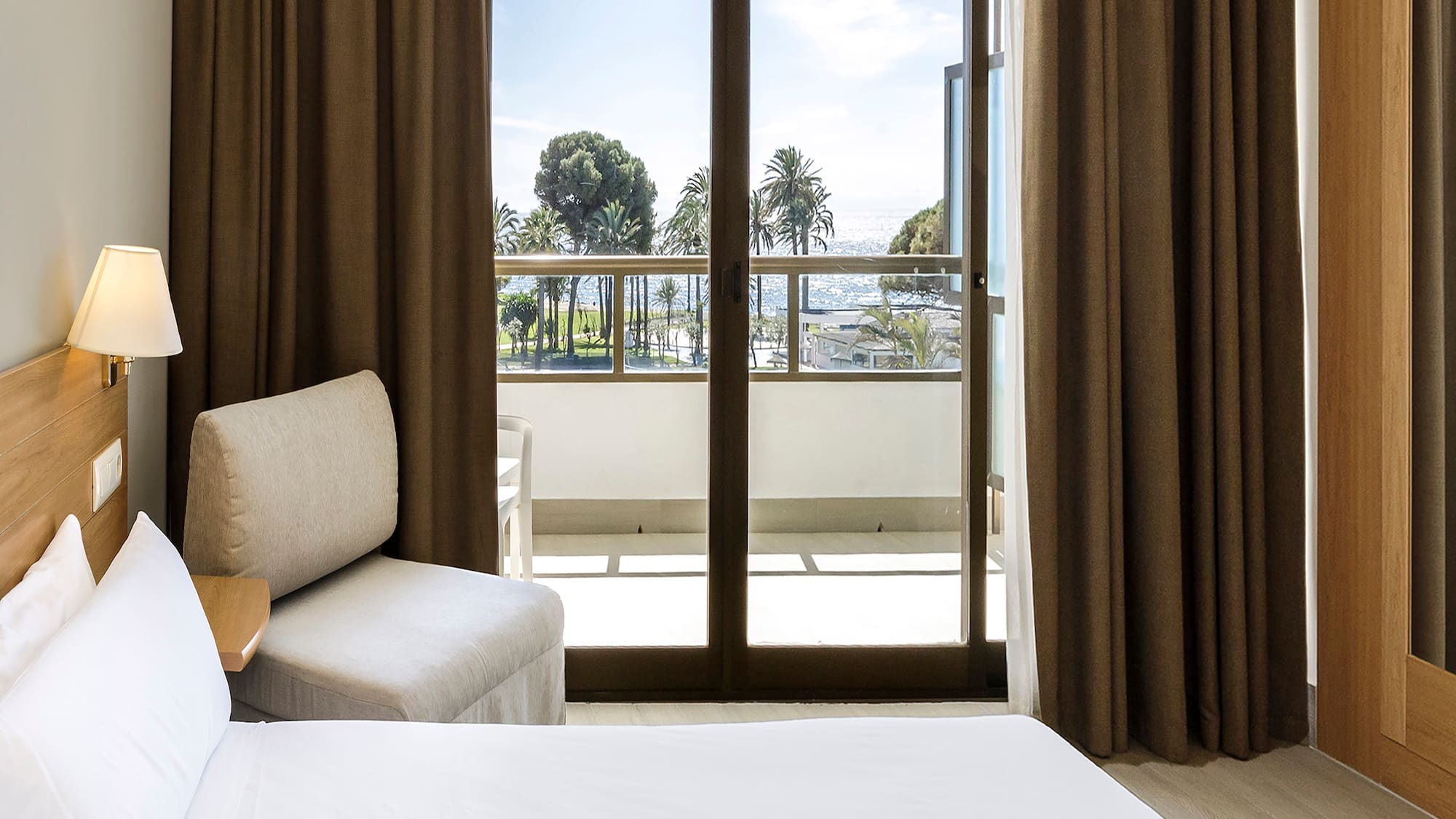 a room with a bed and a glass door