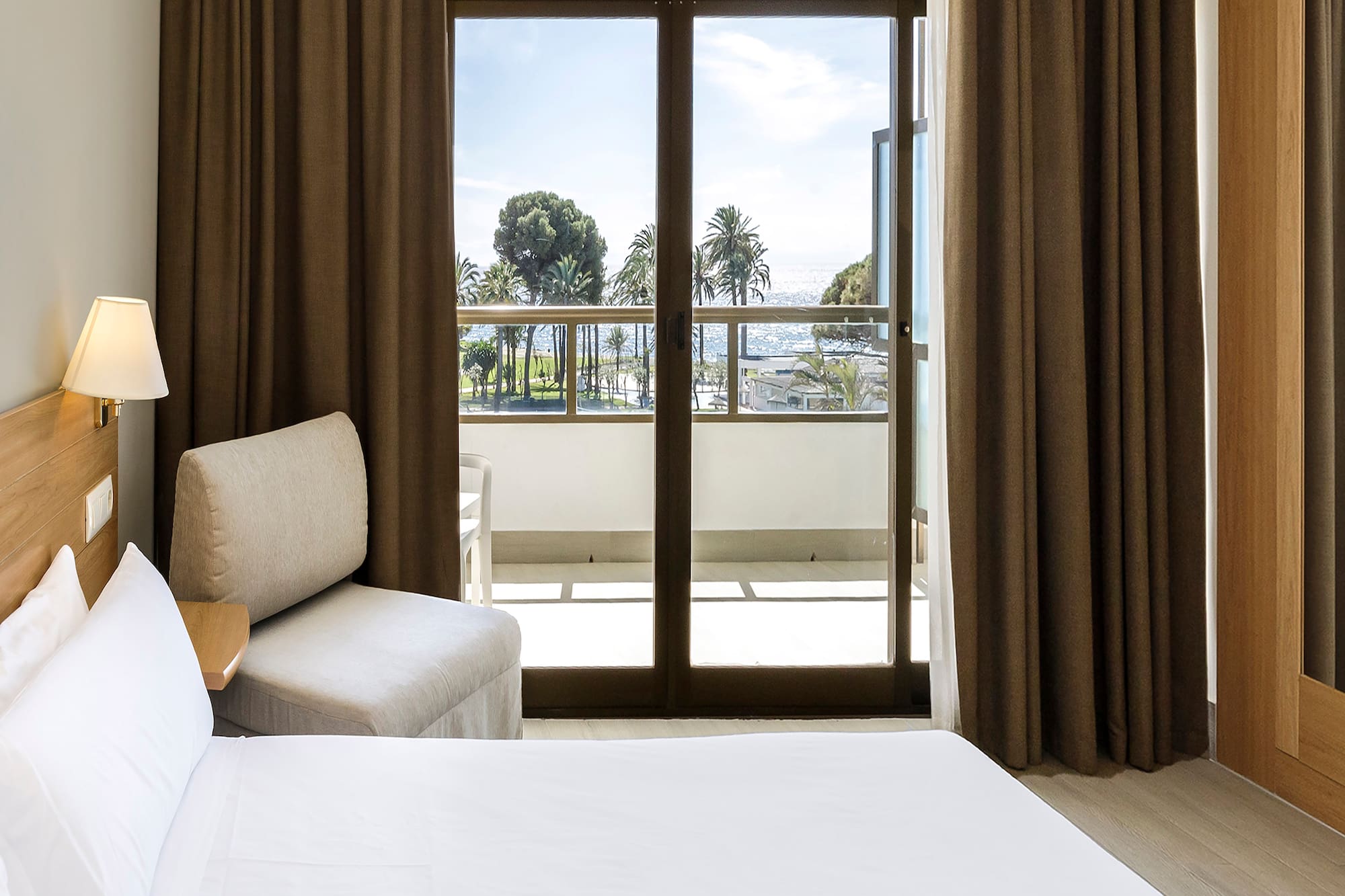 a room with a bed and a glass door