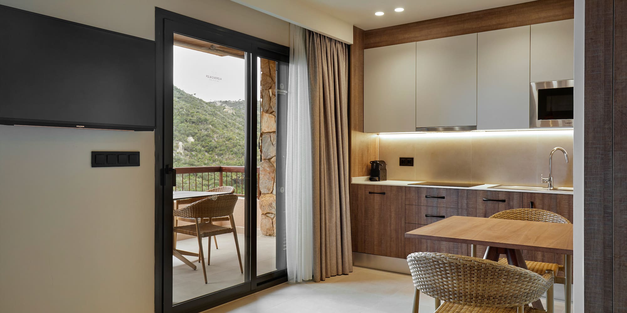 a room with a table and chairs and a television