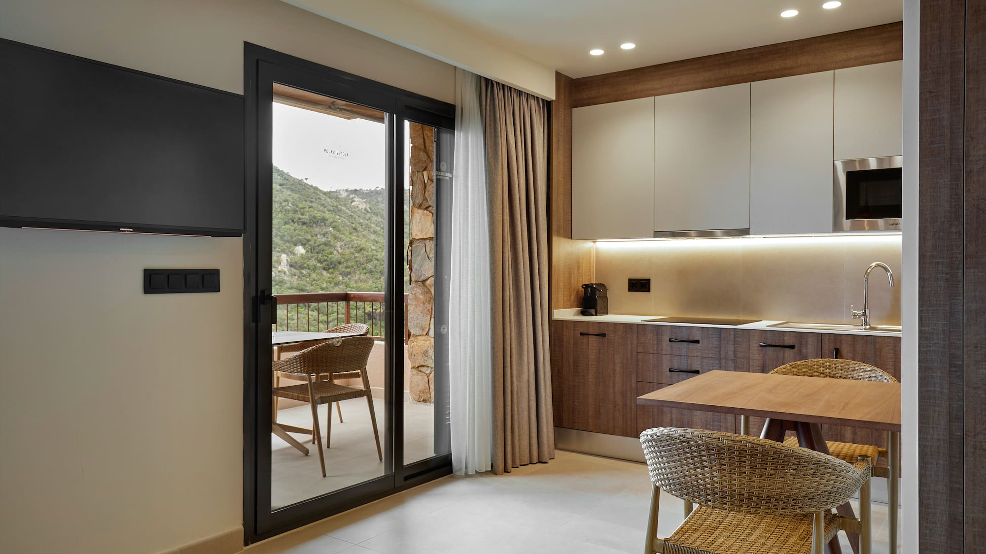 a room with a table and chairs and a television