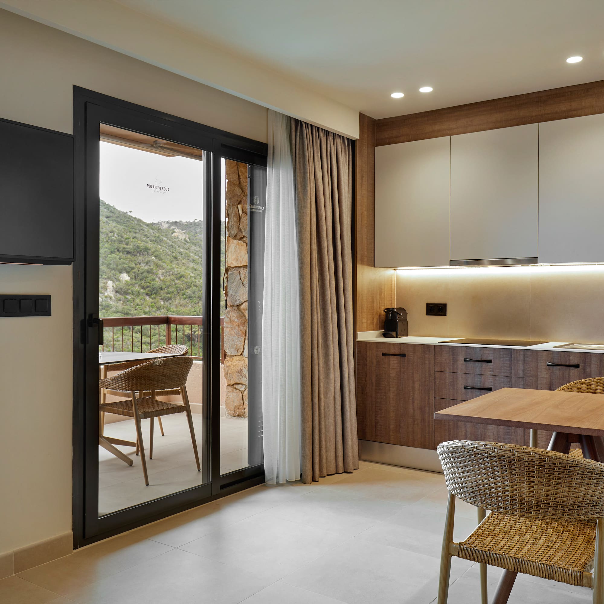 a room with a table and chairs and a television.