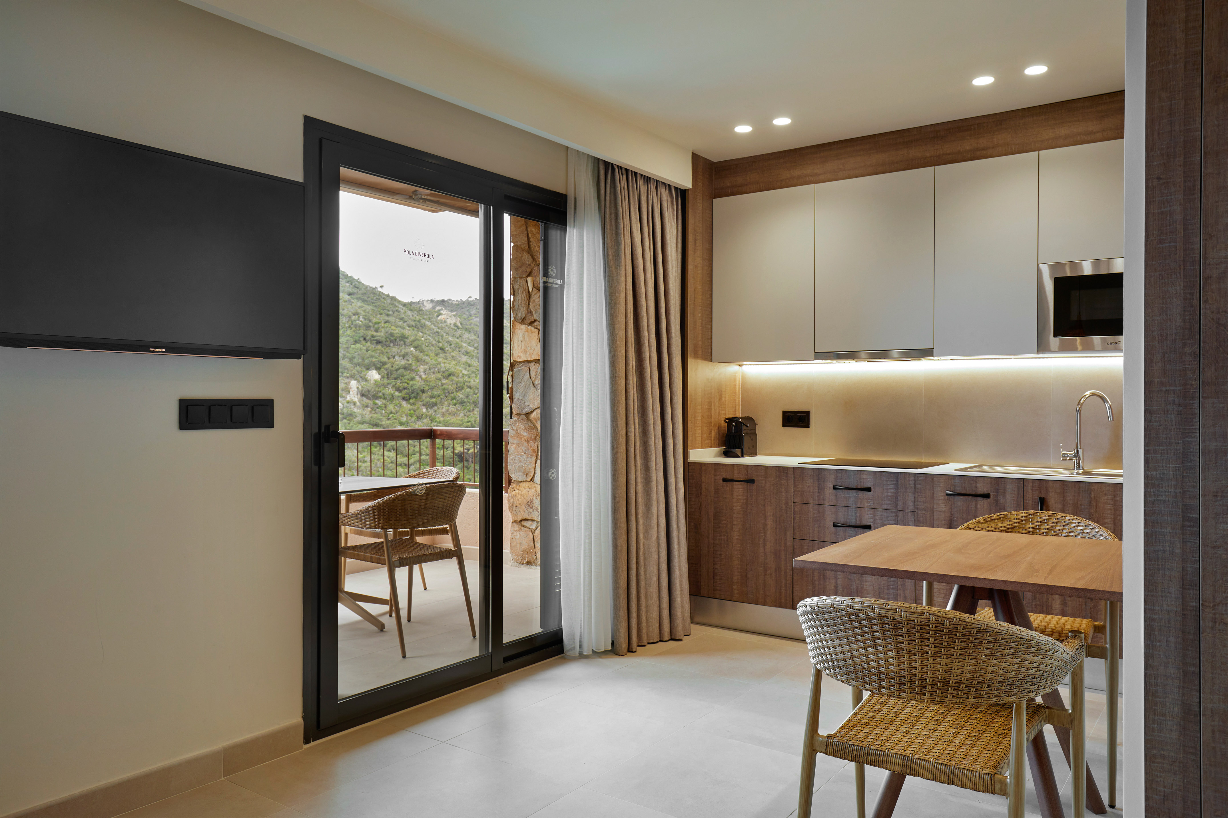 a room with a table and chairs and a television.