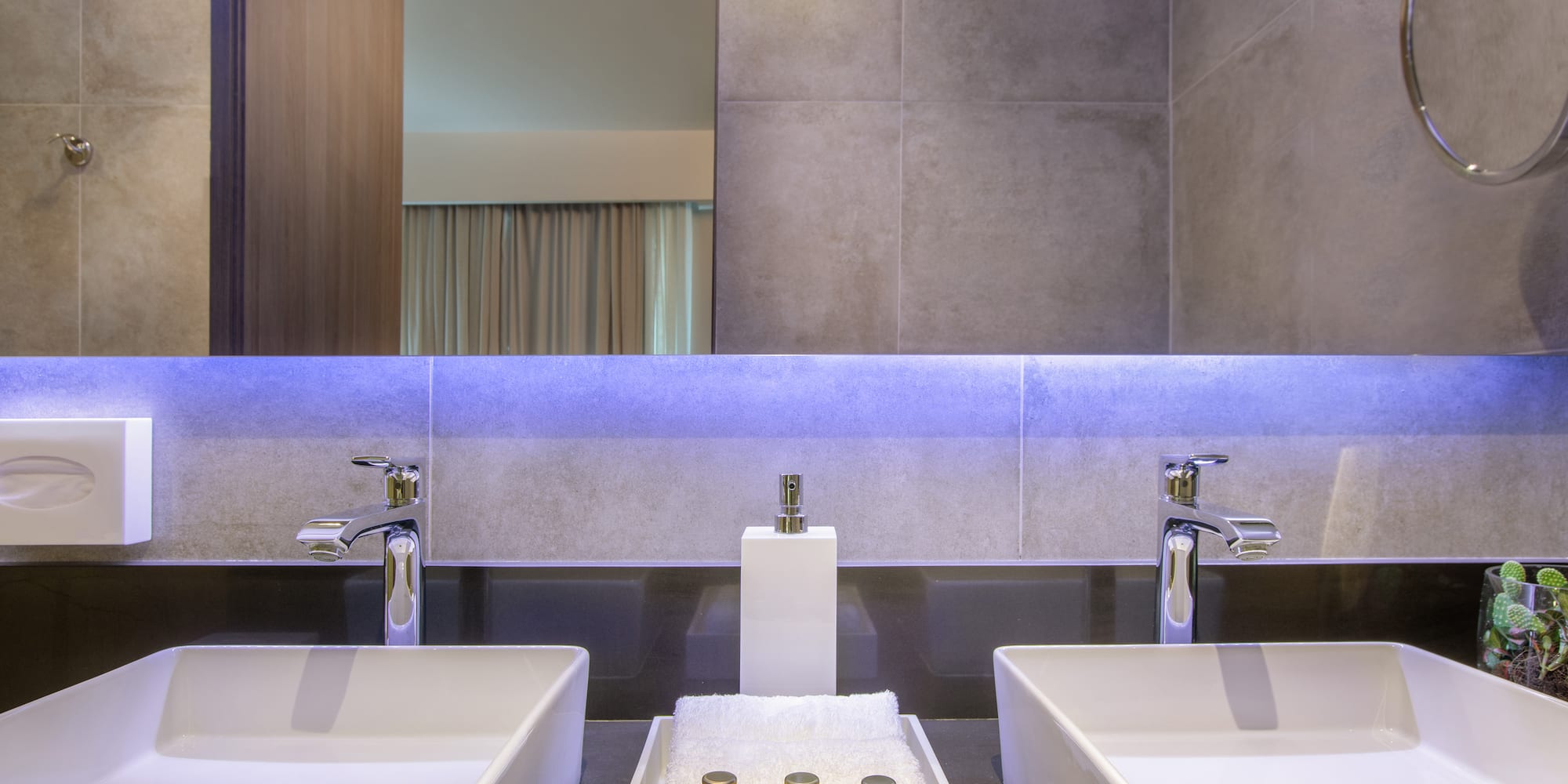 a bathroom with two sinks and a mirror