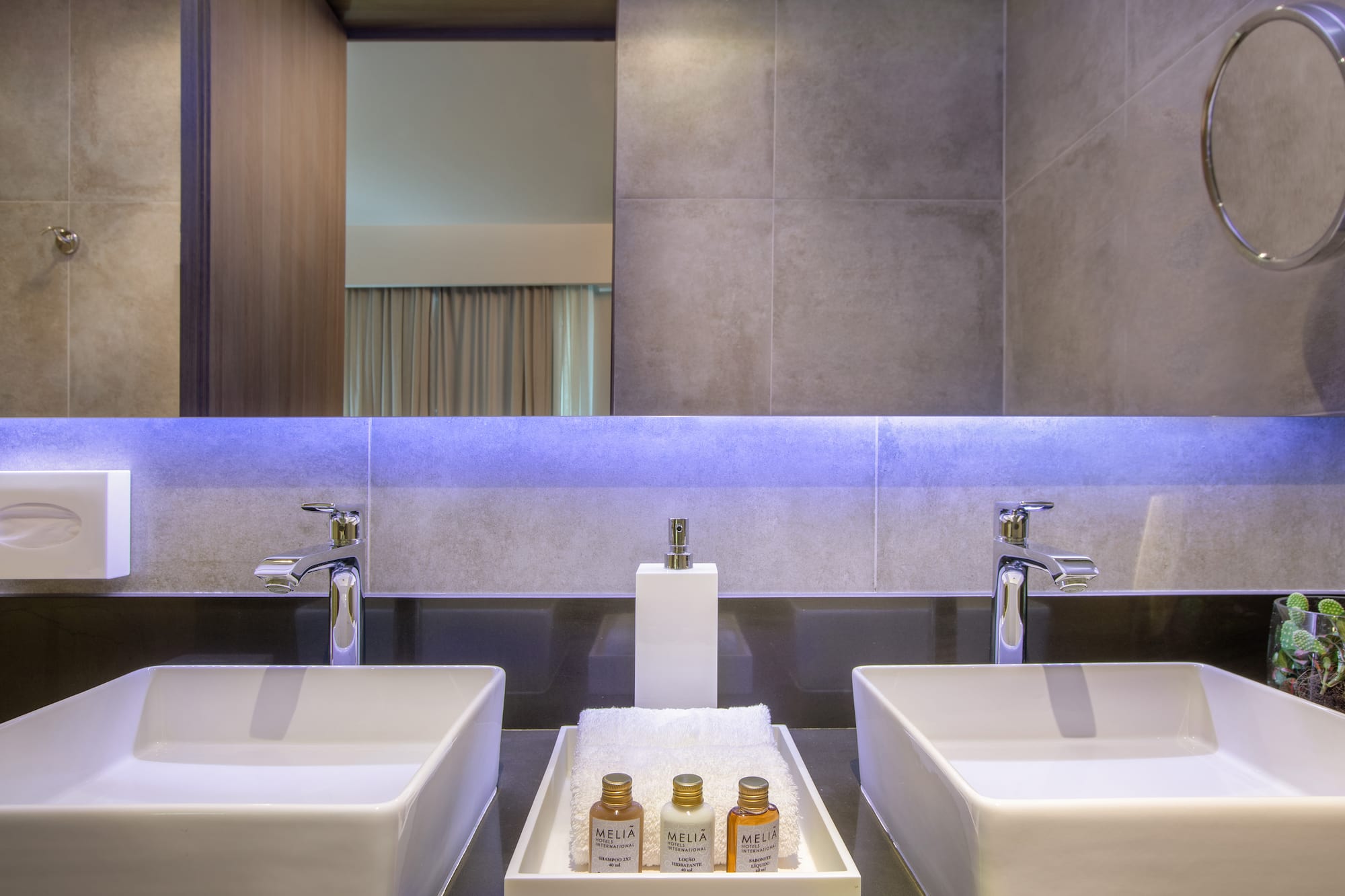 a bathroom with two sinks and a mirror