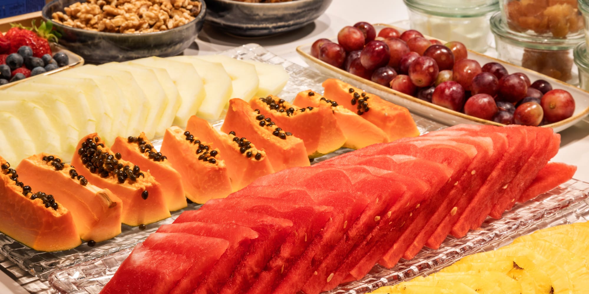 a table with different fruits and nuts