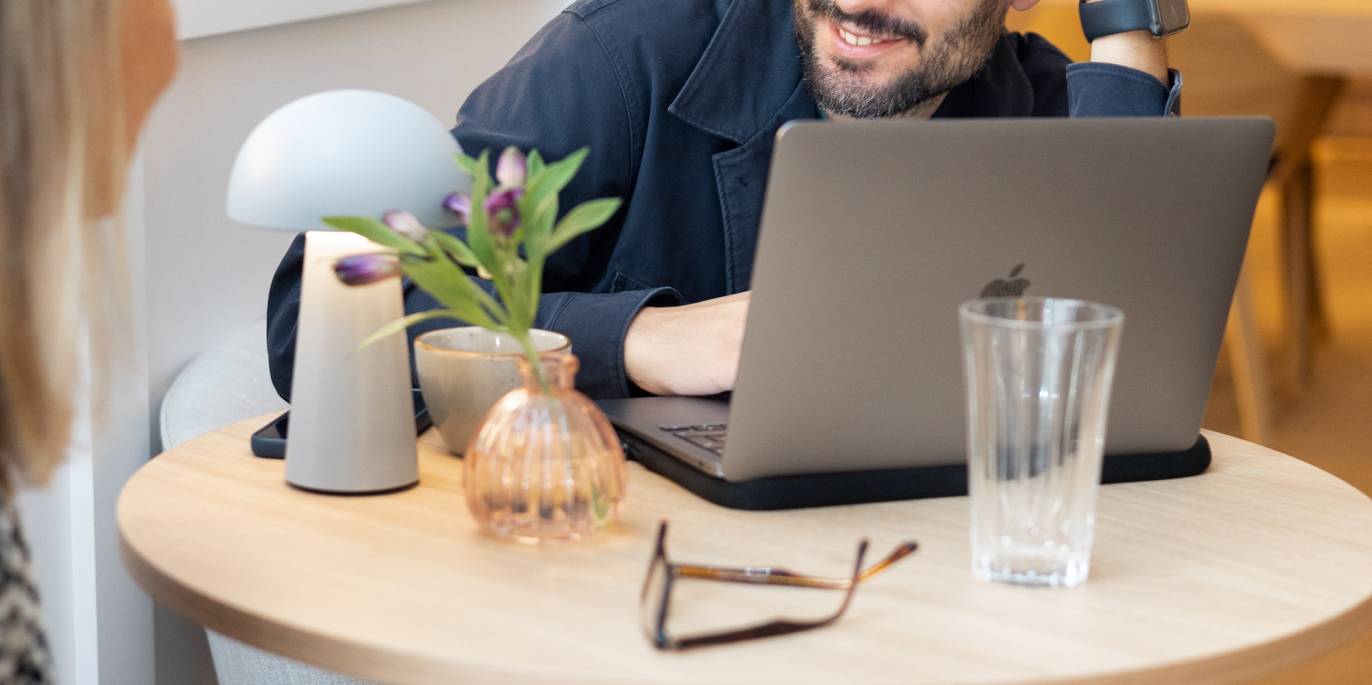 a man sitting at a table with a laptop