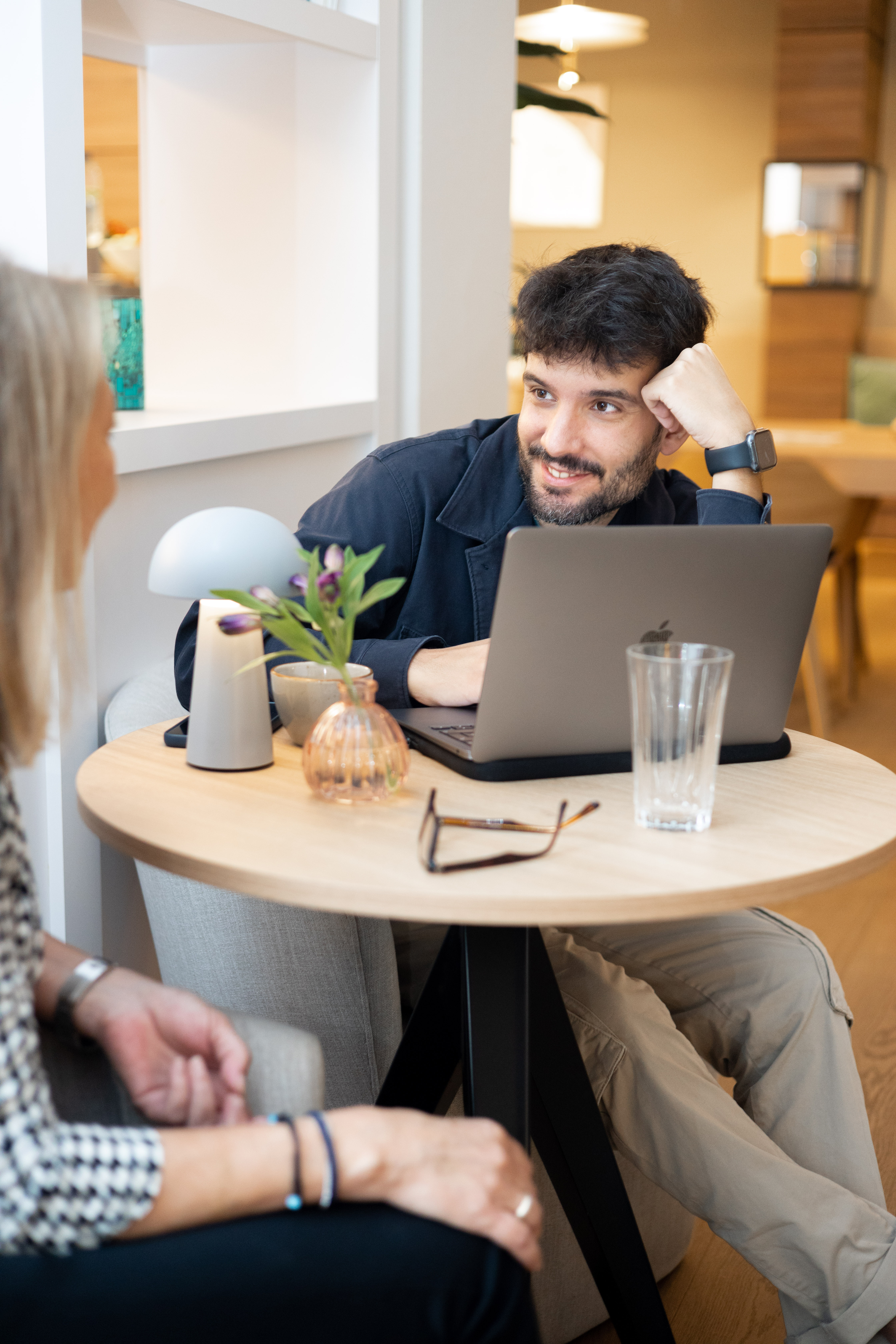a man sitting at a table with a laptop