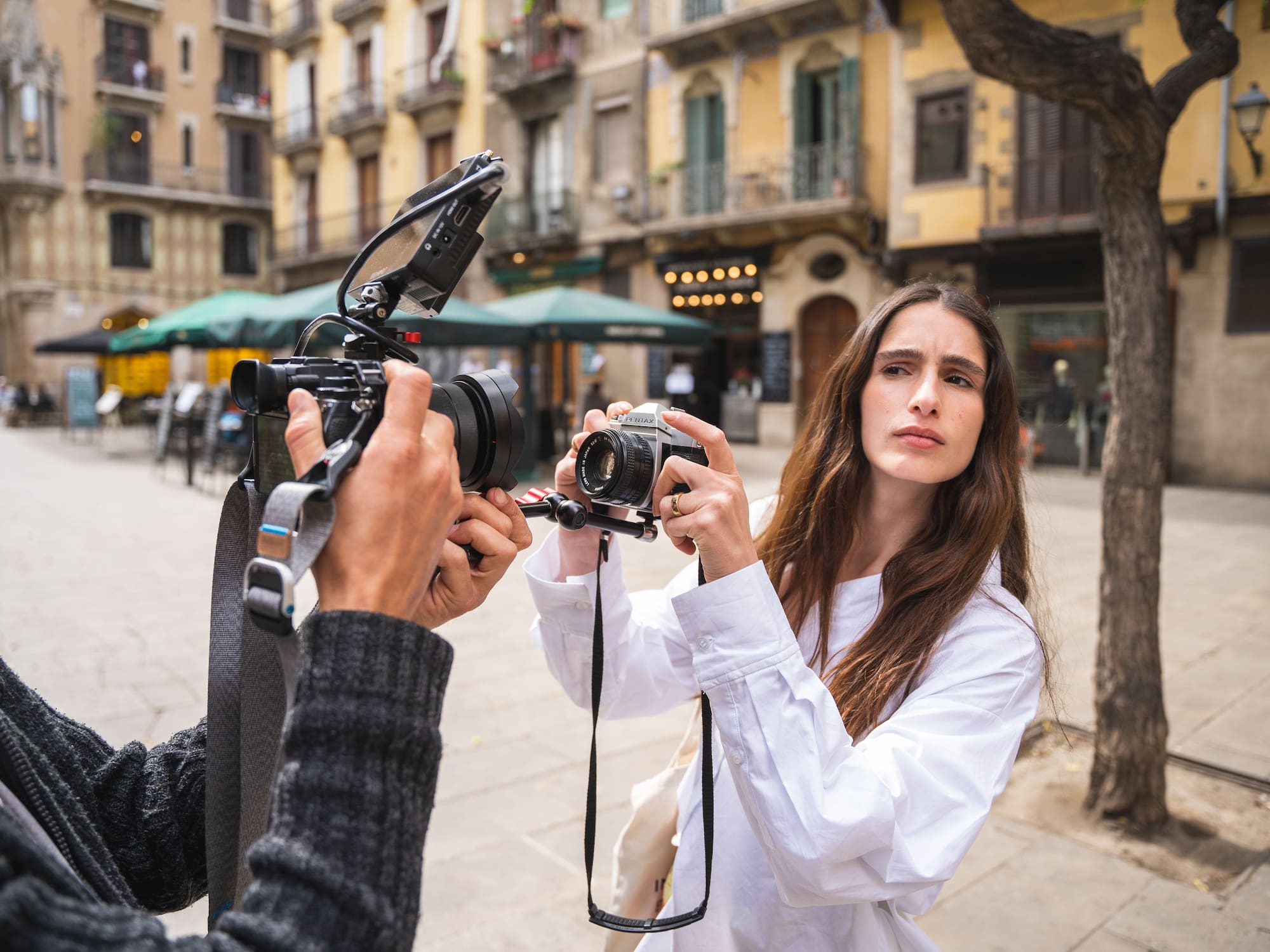 a woman taking a picture of a man